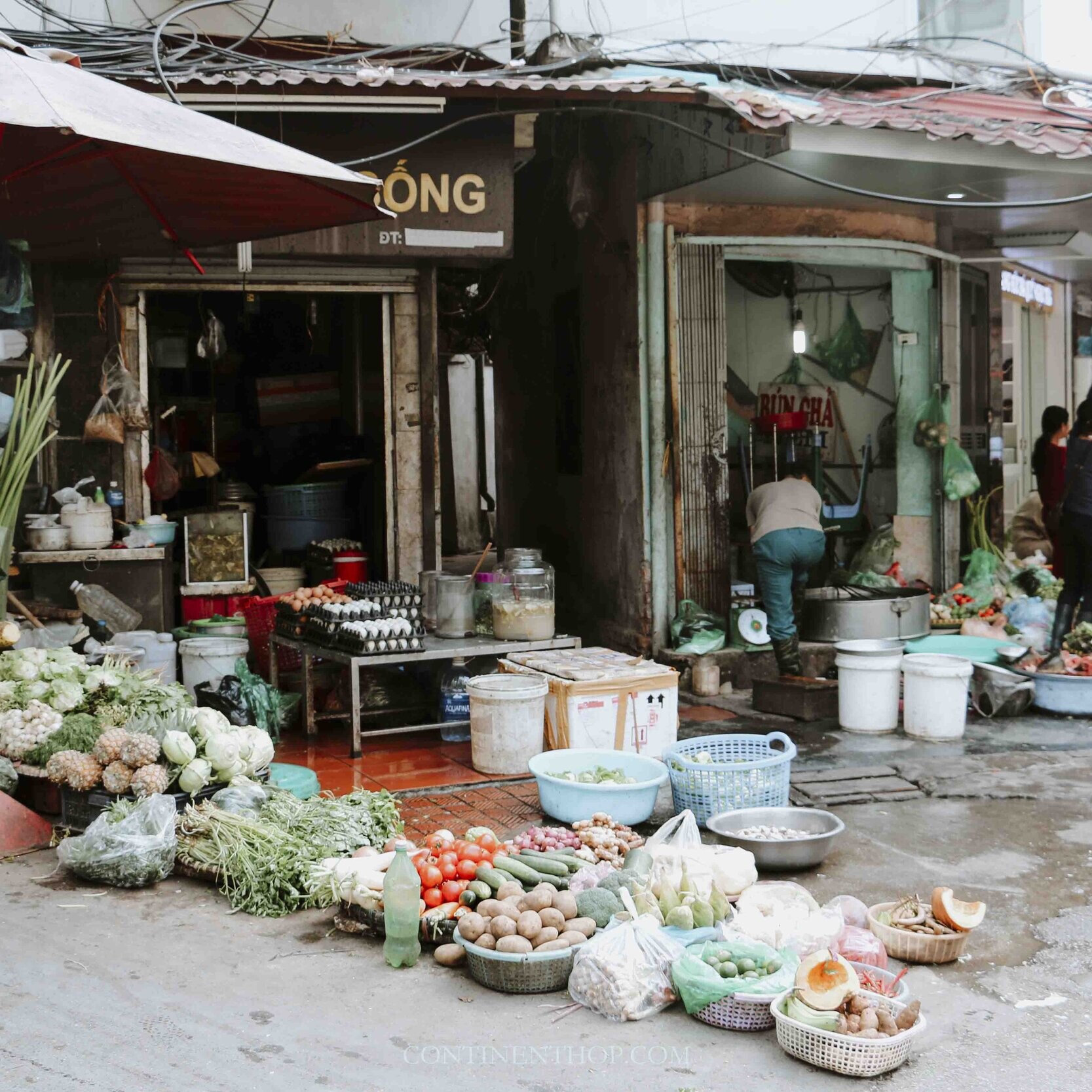 A woman selling vegetables on the street in Hanoi