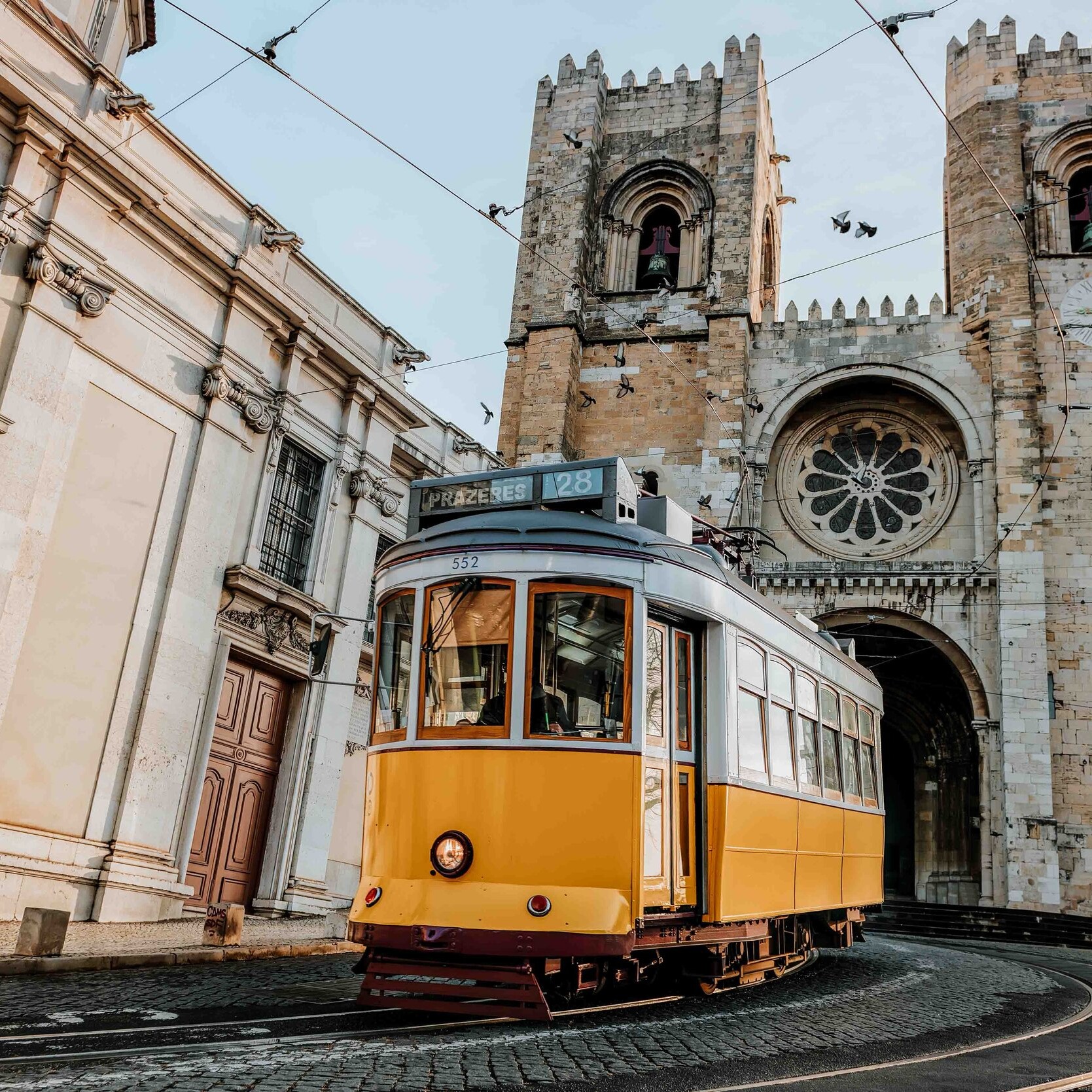 A yellow tram on the streets in Lisbon in Portugal on a 90 days in Europe itinerary