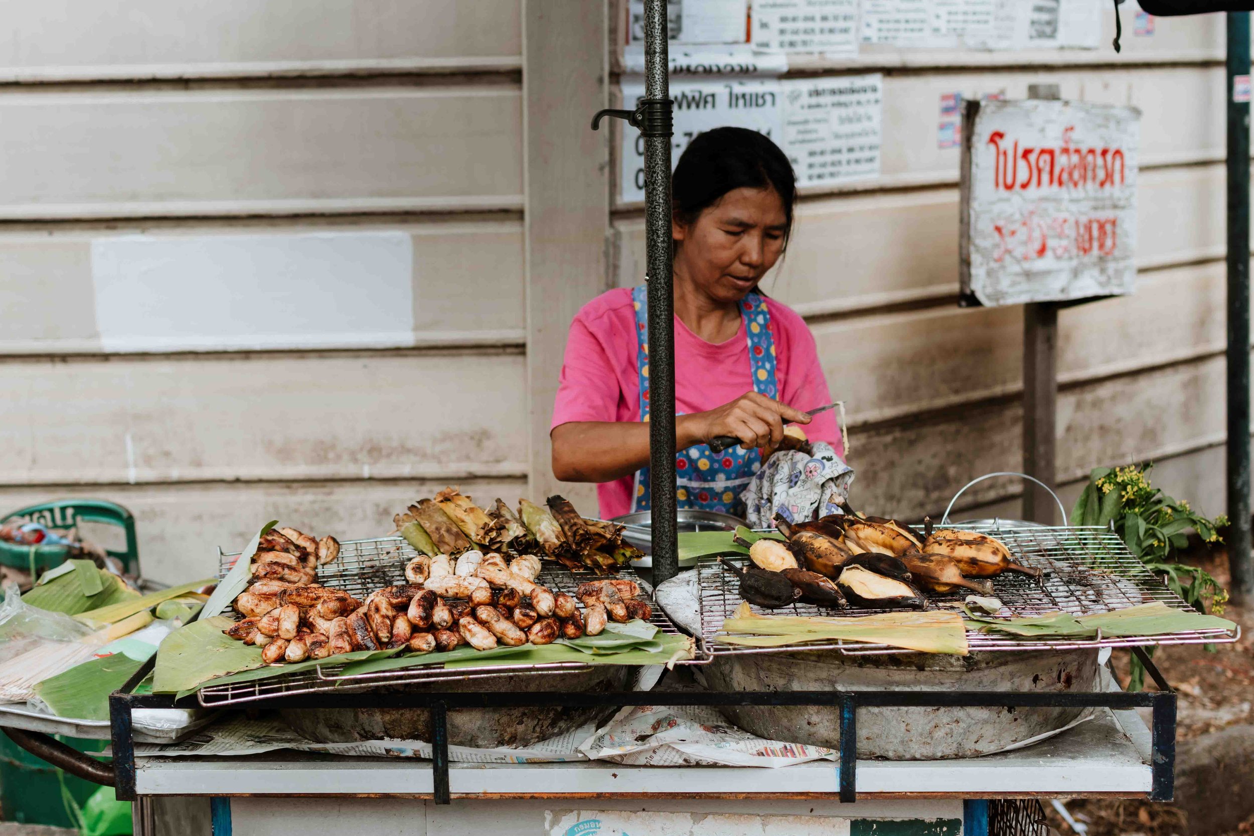 A vendor making and selling street food in phuket on a phuket thailand itinerary