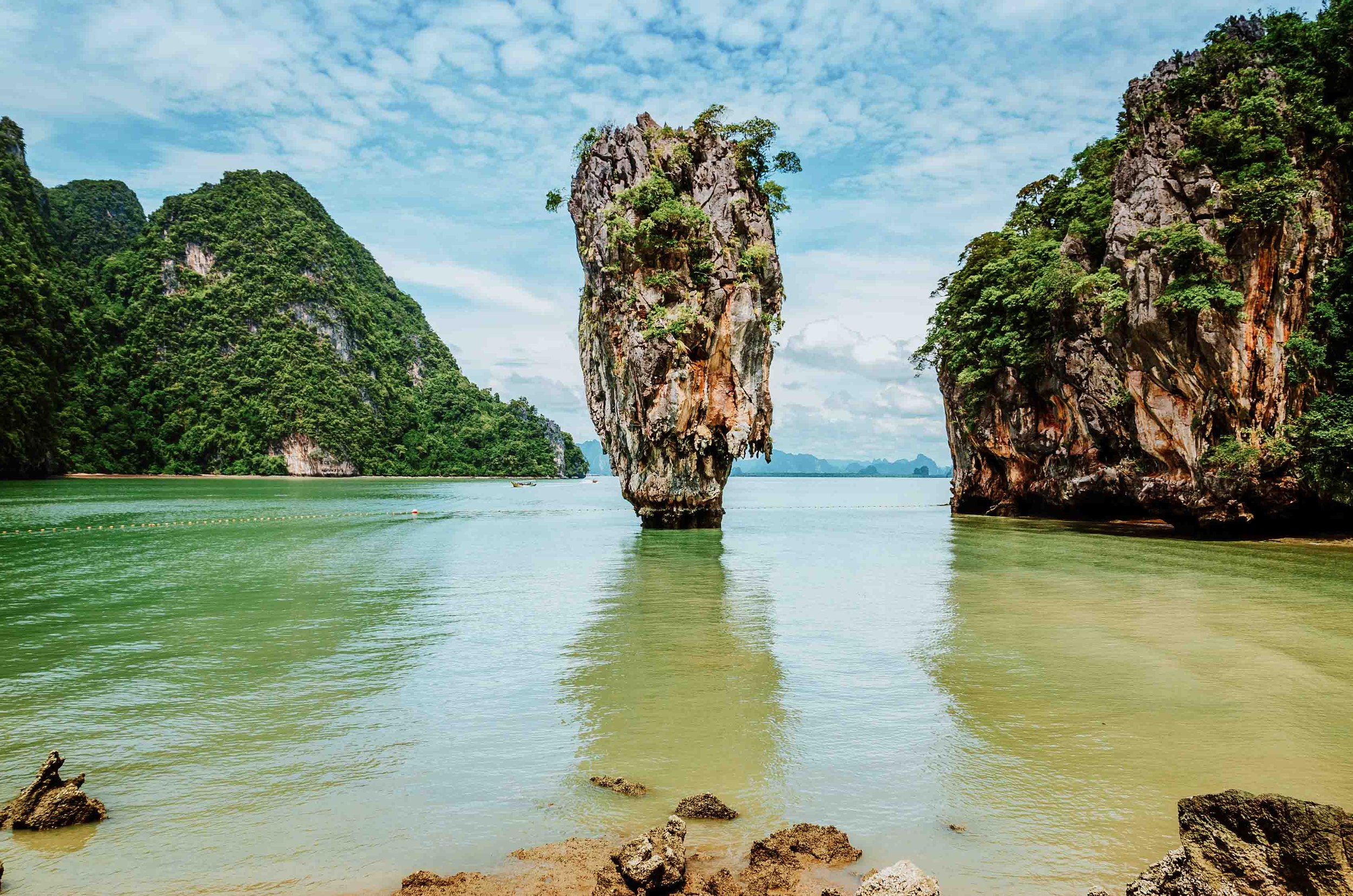 A suspended huge rock in the sea at James Bond island on a phuket 7 day itinerary