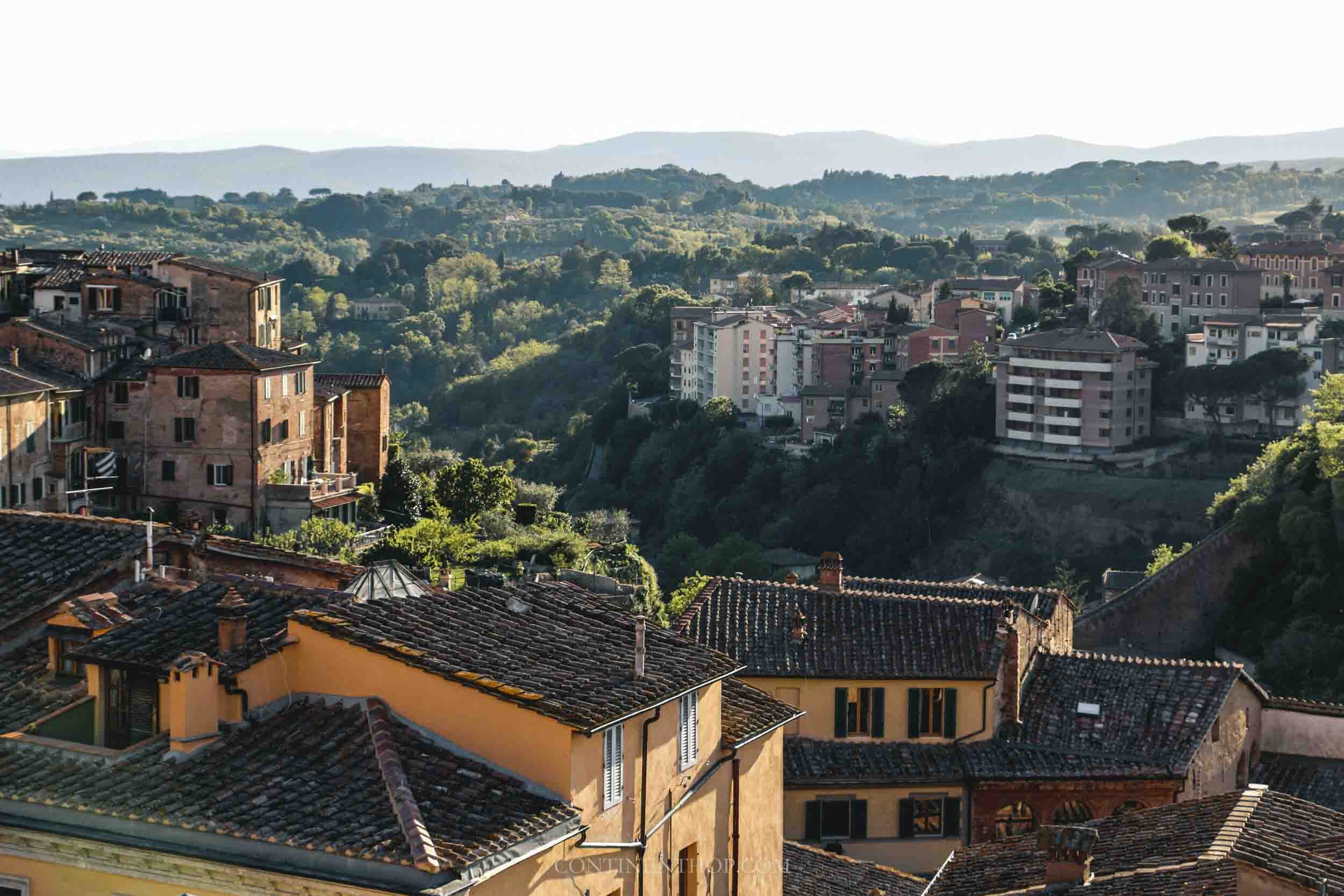 View of the rooftops and mountains in Siena Tuscany Italy