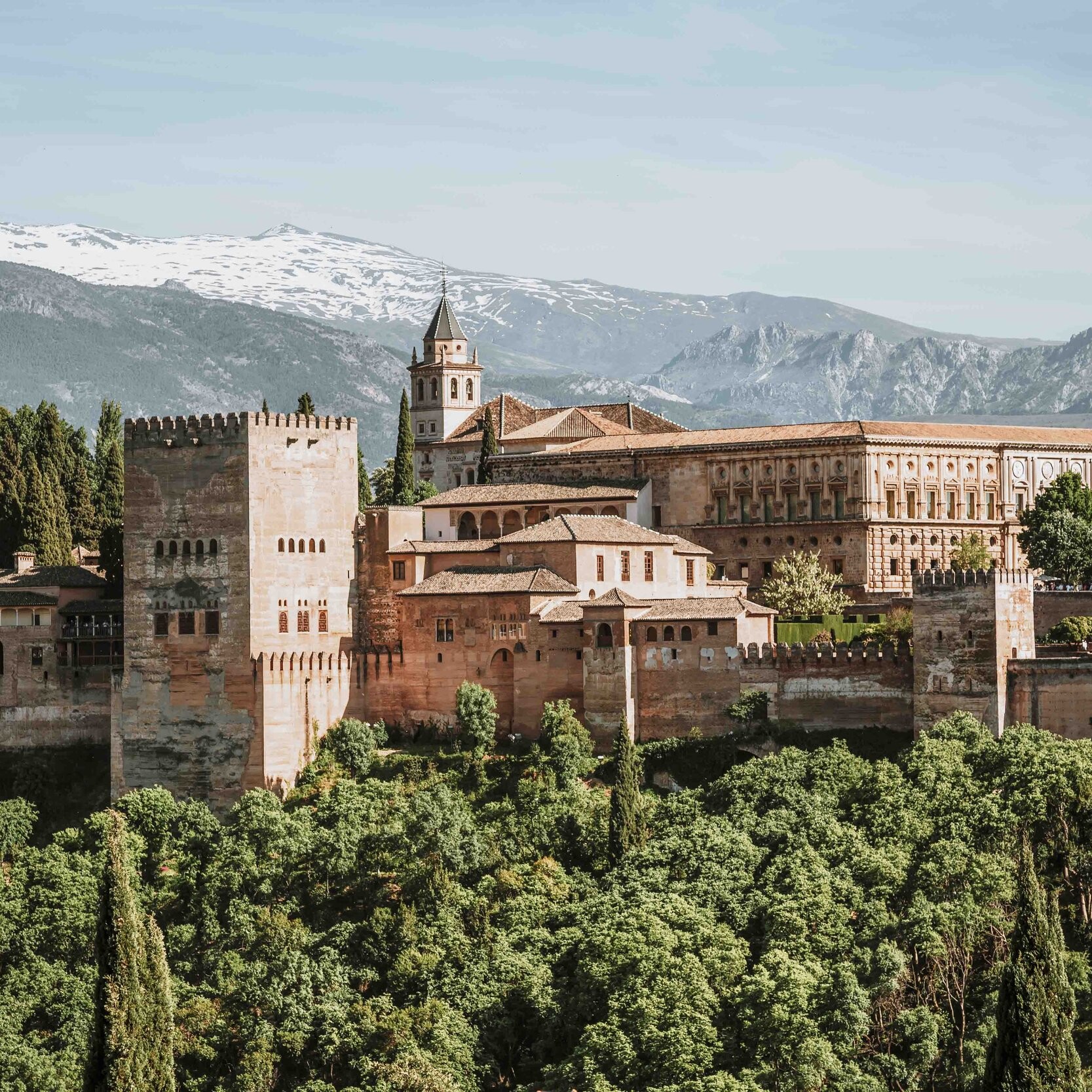 The Alhambra during the day with hills in the back