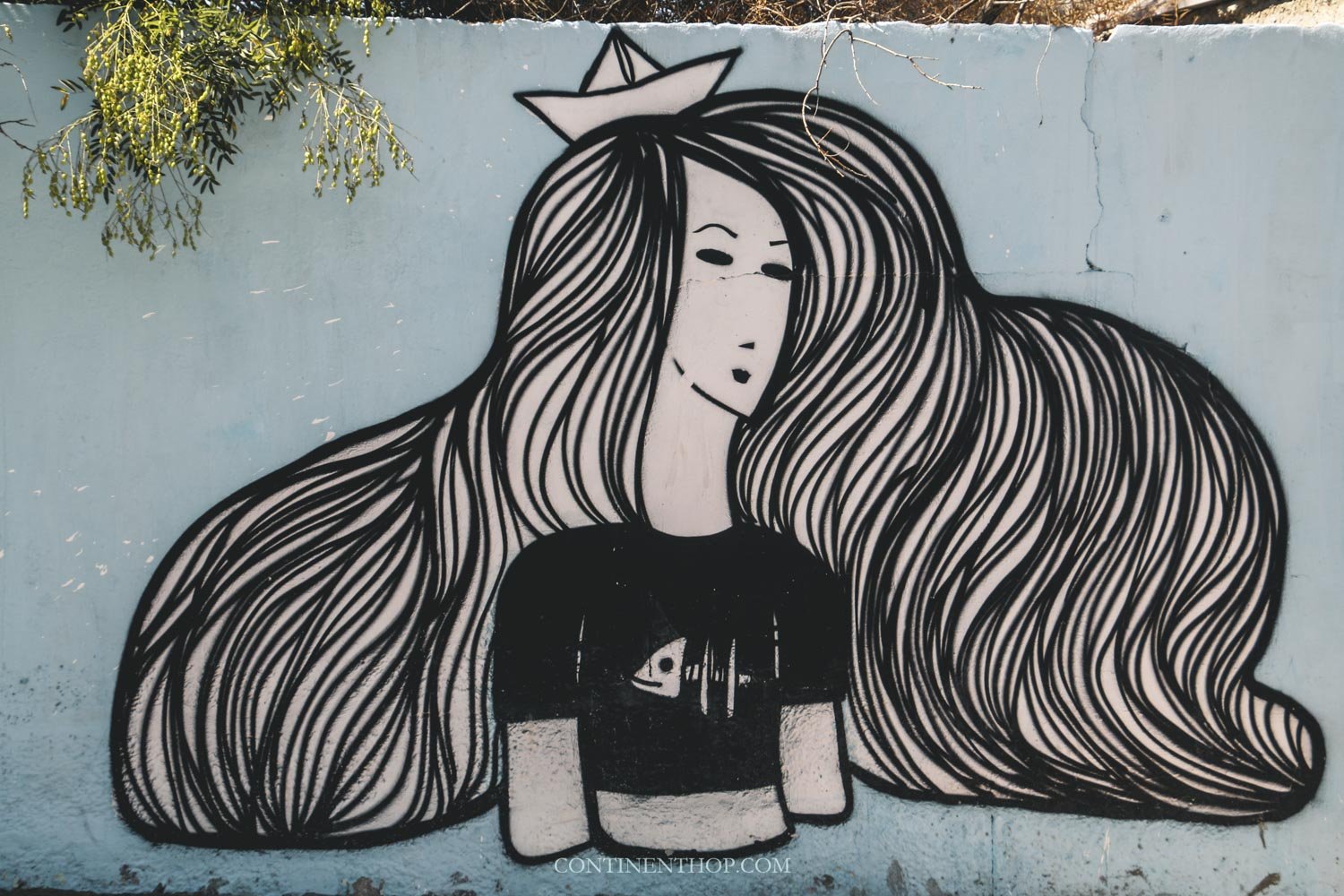 Street art of a woman with thick hair in amman - things to do in Amman