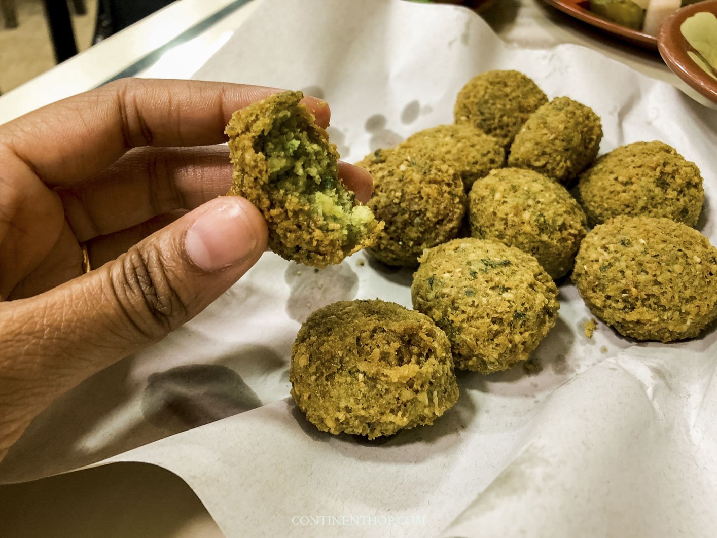 Person holding falafel in downtown amman in what to see in amman - things to do in amman