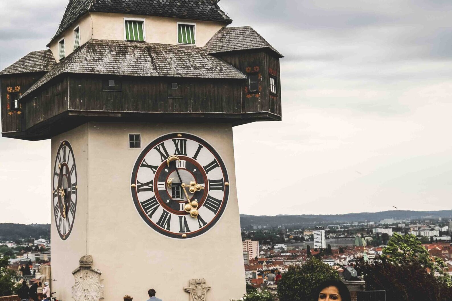 Woman standing near the clock tower in Graz on your Austria Itinerary