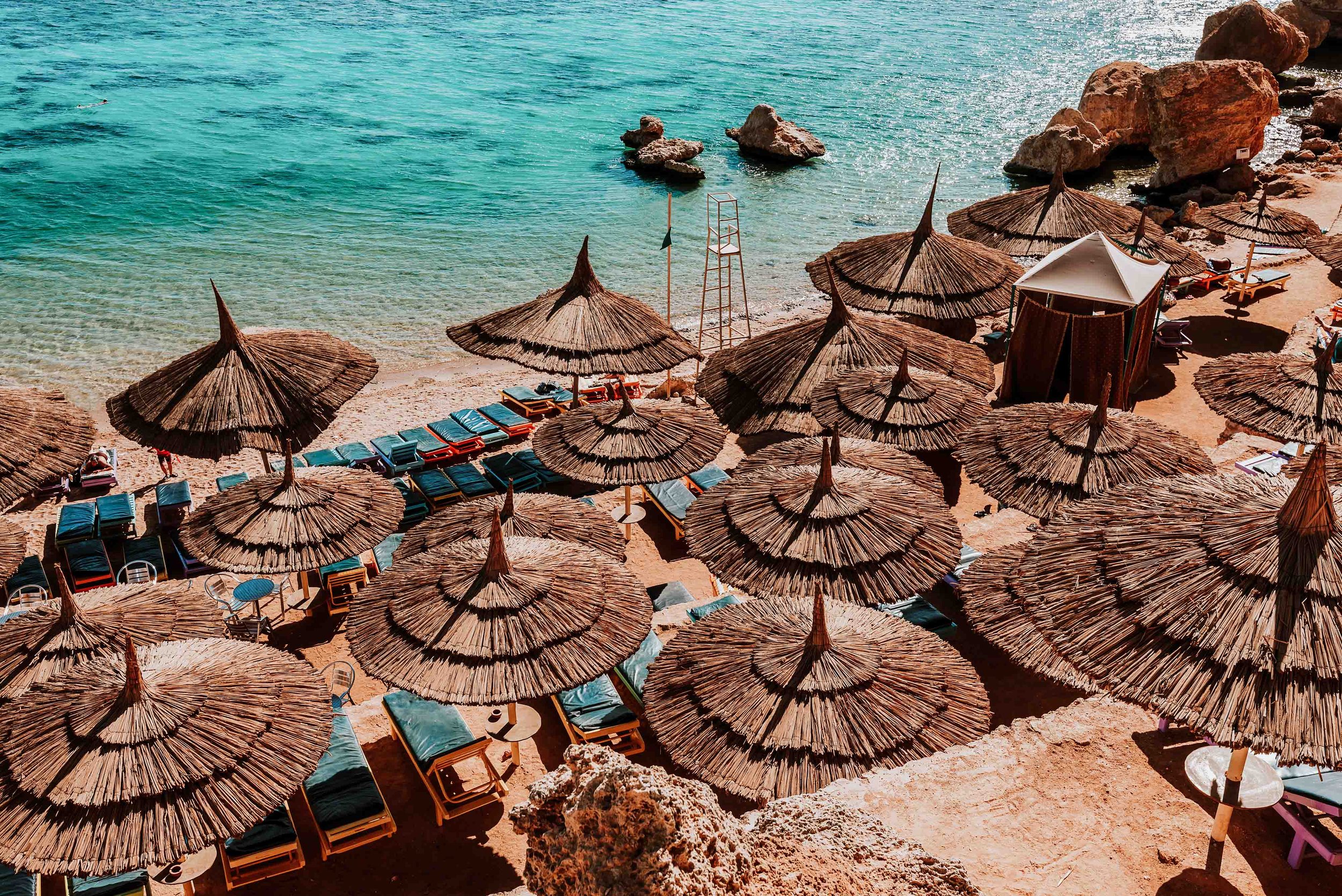 Beach huts by the sea on a sunny day in Sharm El Shaikh on a 8 days Egypt tour