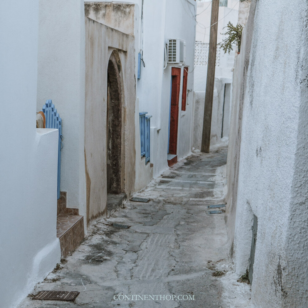 An alley in Emborio with red and blue doors in Santorin Emporio