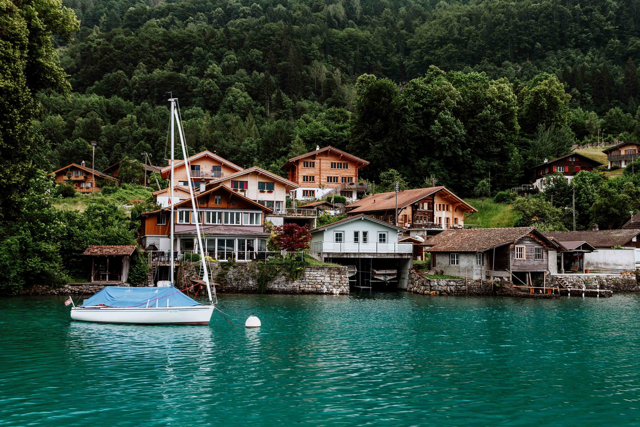 A boat with classy houses behind in Interlaken on a france and Switzerland itinerary 10 days