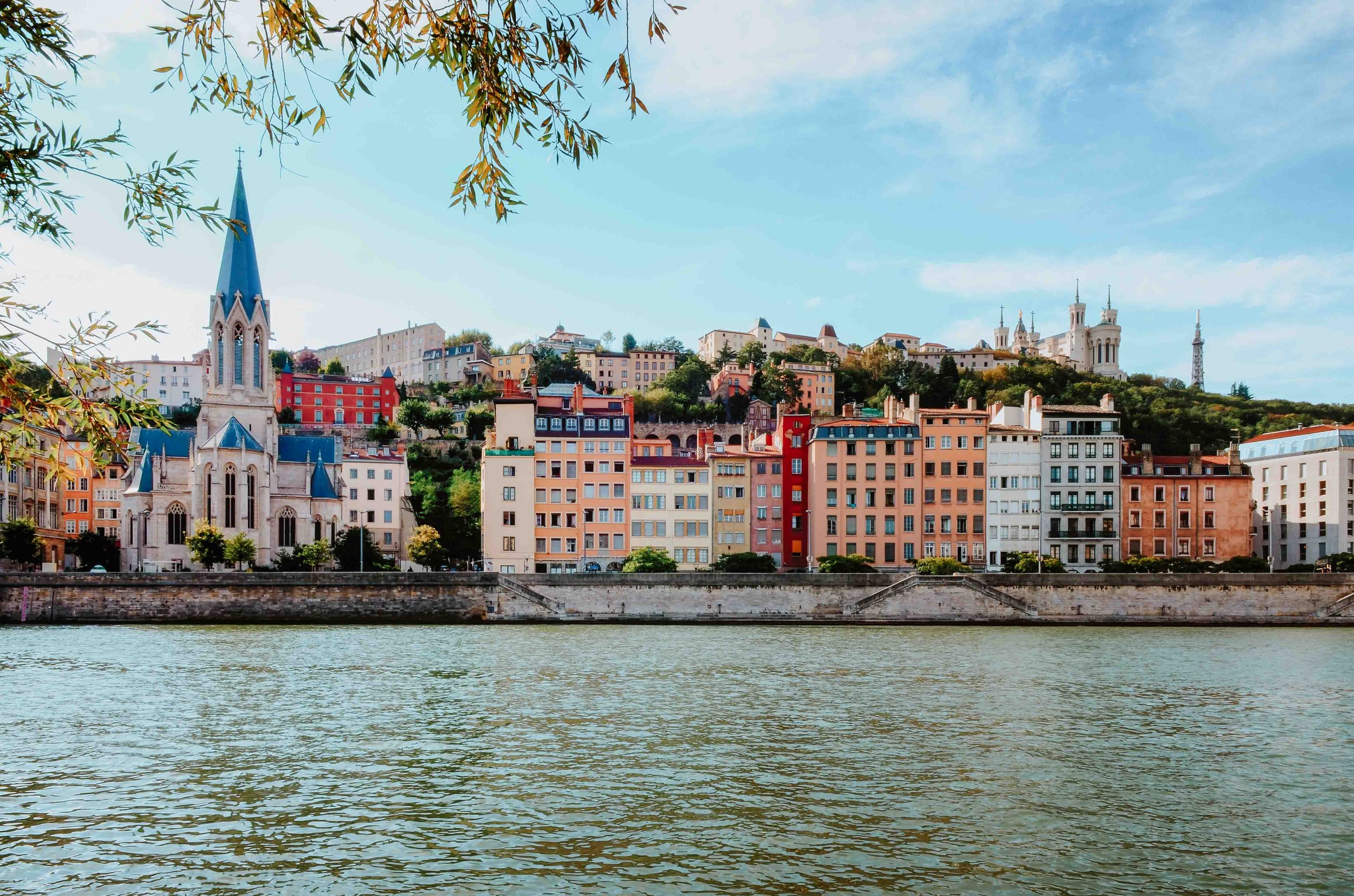 Colourful buildings by the river in Lyon on best itinerary france and switzerland