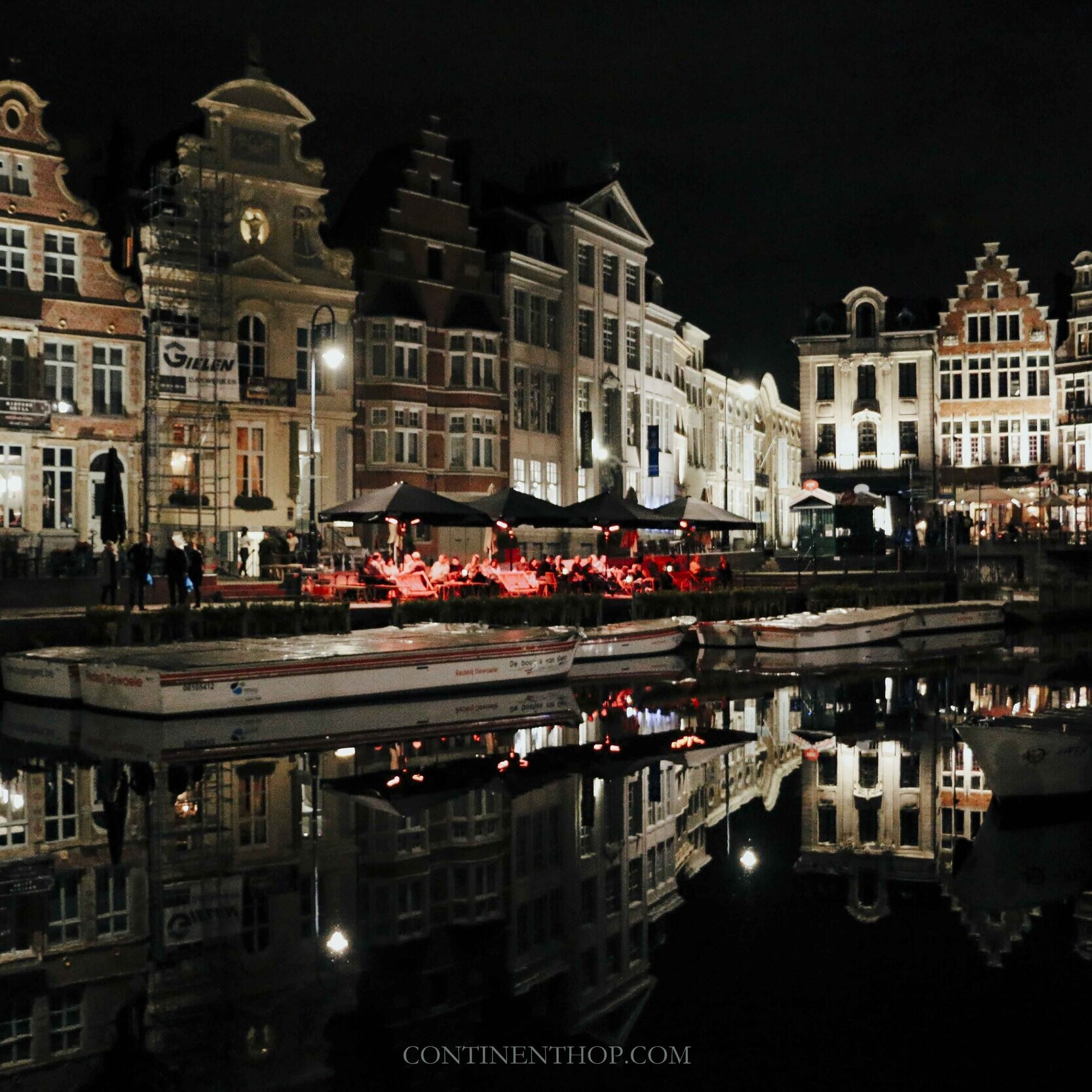 Reflection of houses in the river Leie at night in Ghent