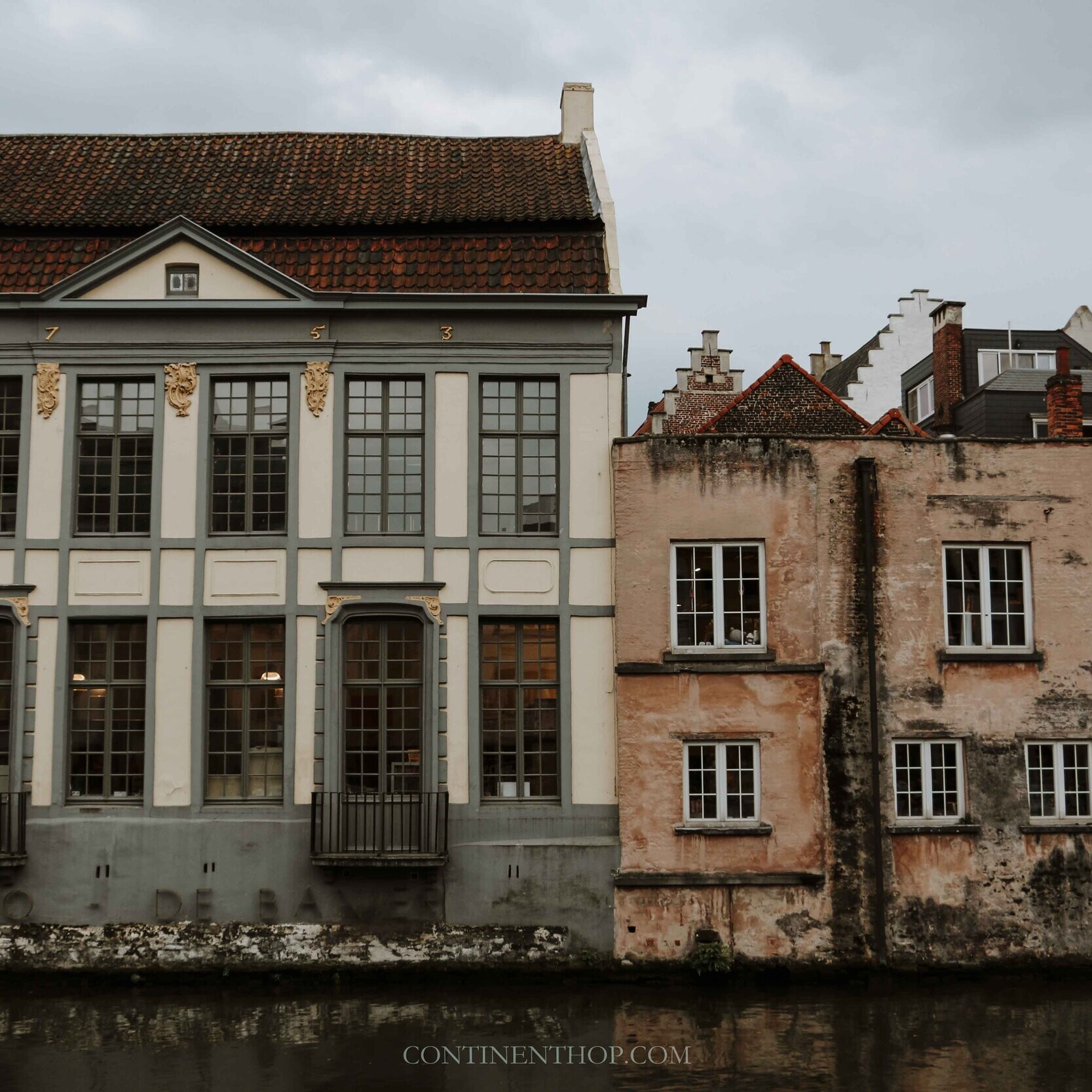 A building with beautiful architecture by the river Leie in Ghent