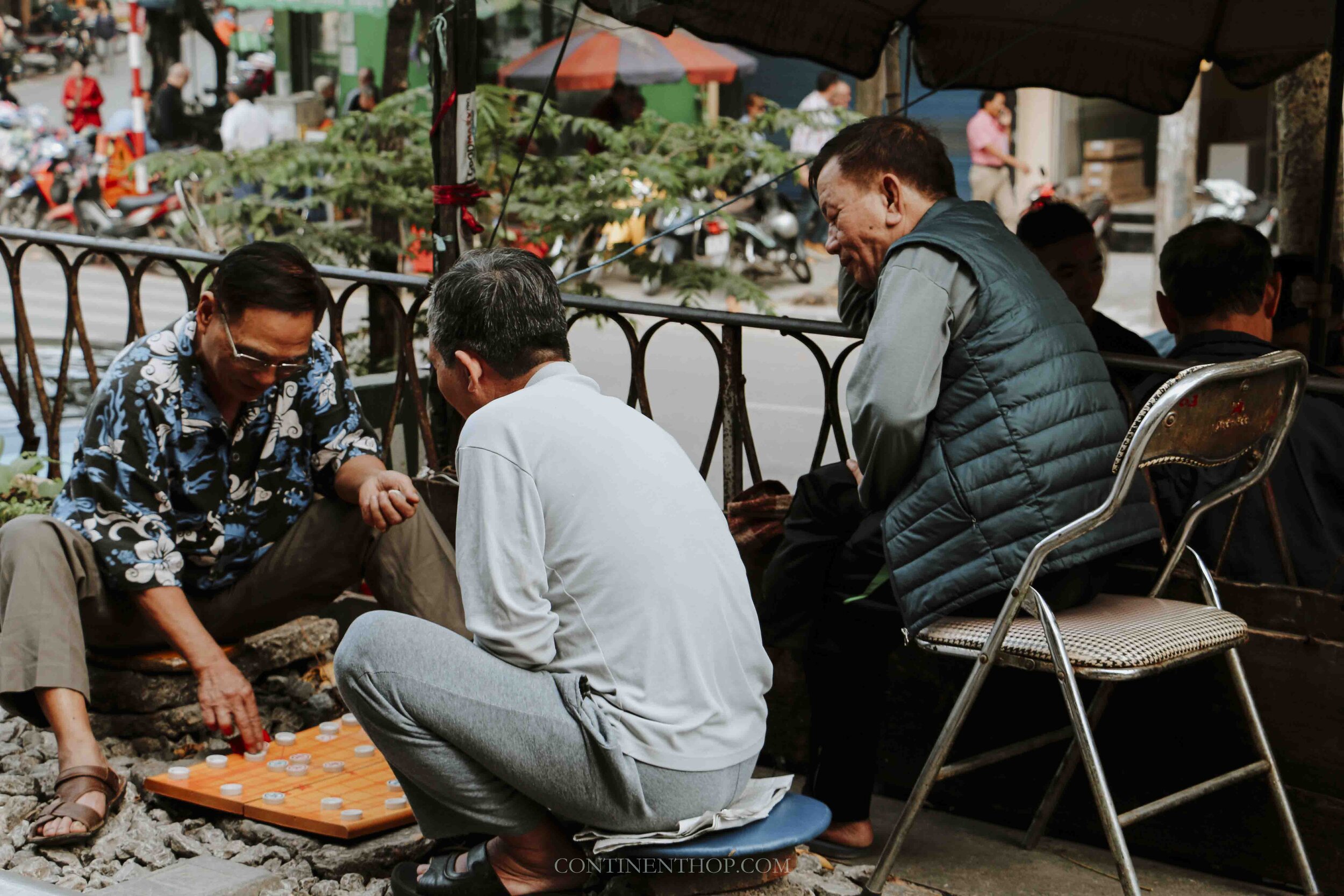 Image of men in Hanoi Vietnam playing a game outdoors