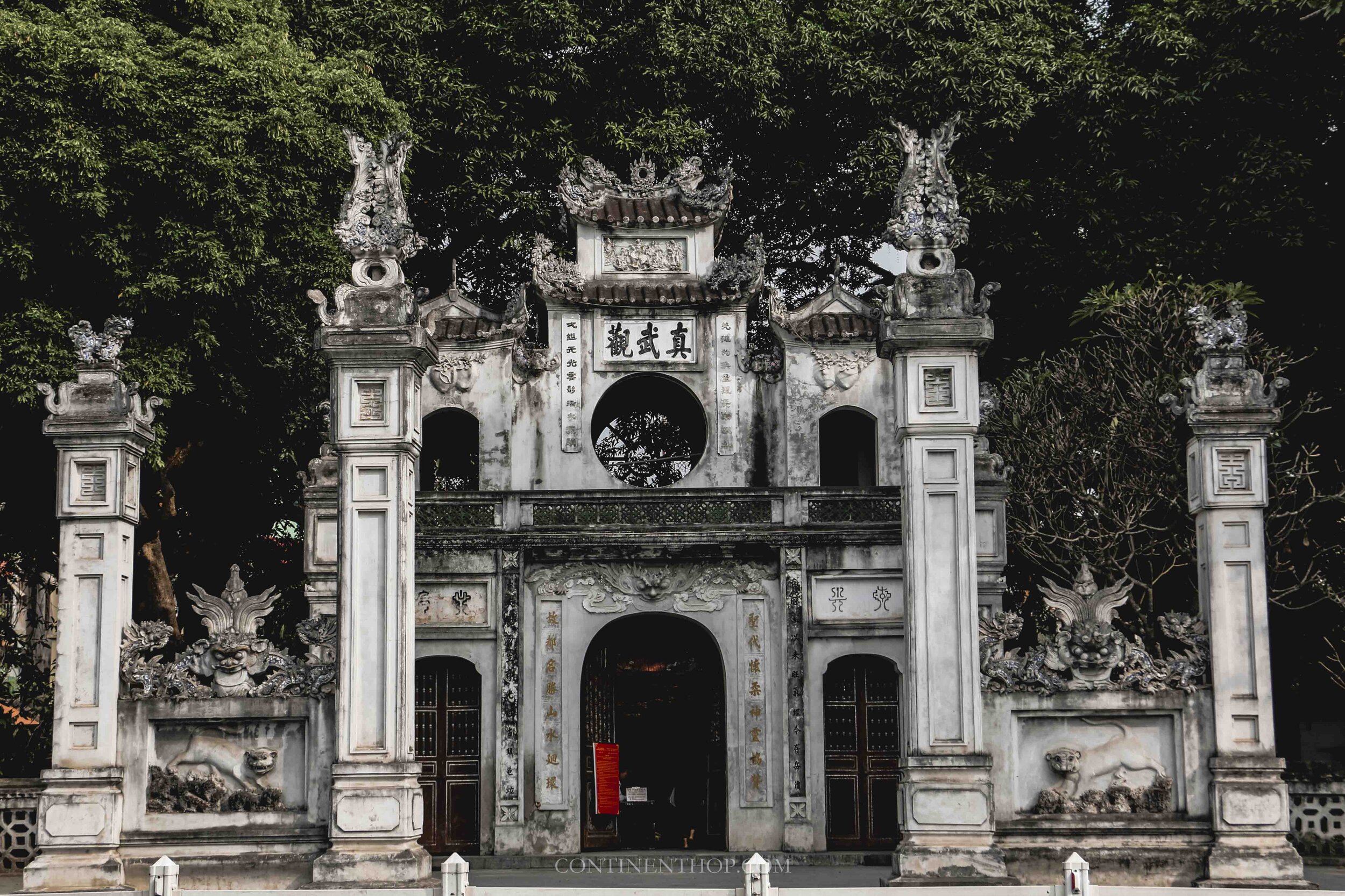 Image of a white arch by West Lake in Hanoi Vietnam