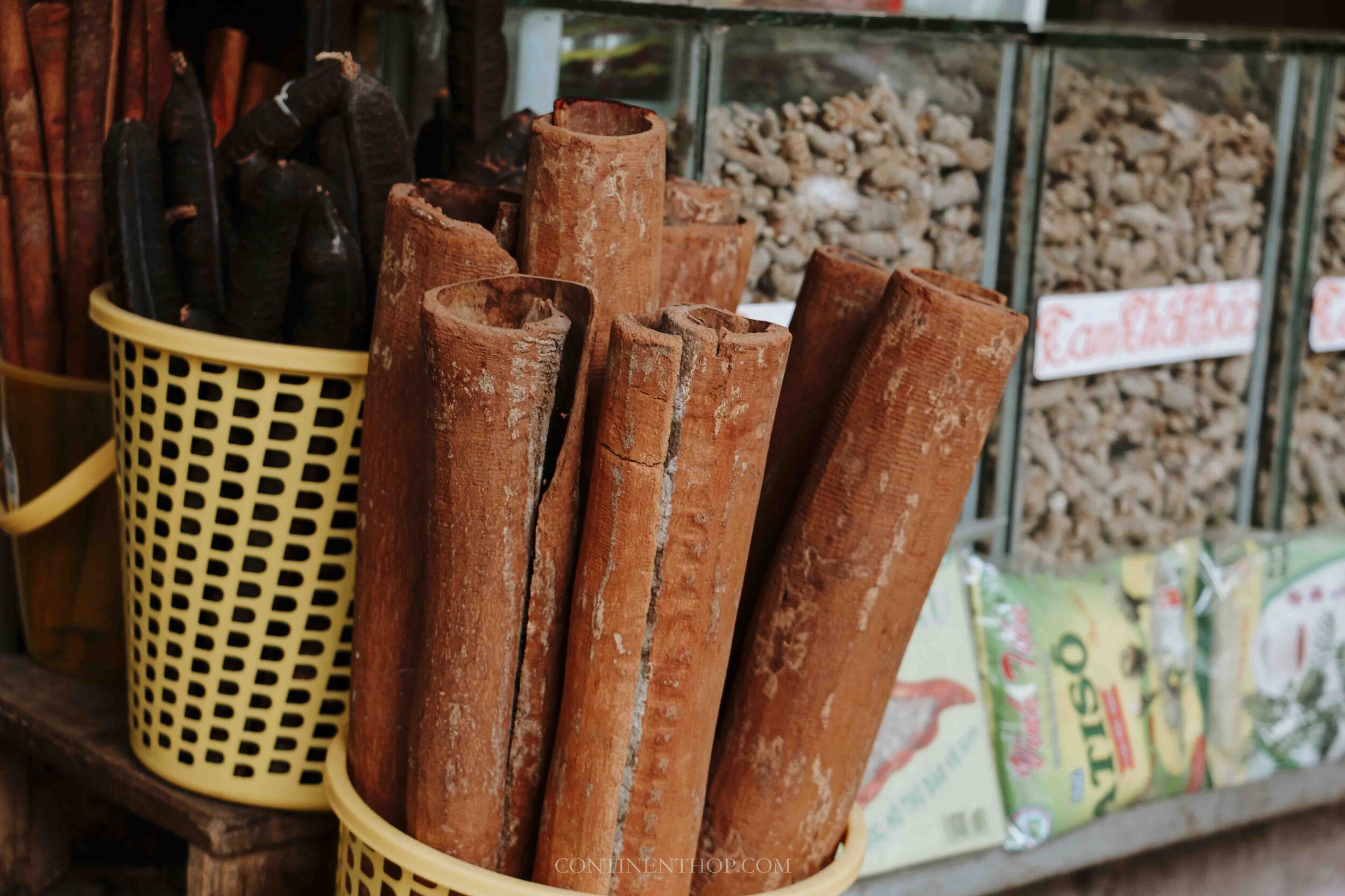 Image of huge cinnamon sticks in a yellow basket in Hanoi Vietnam
