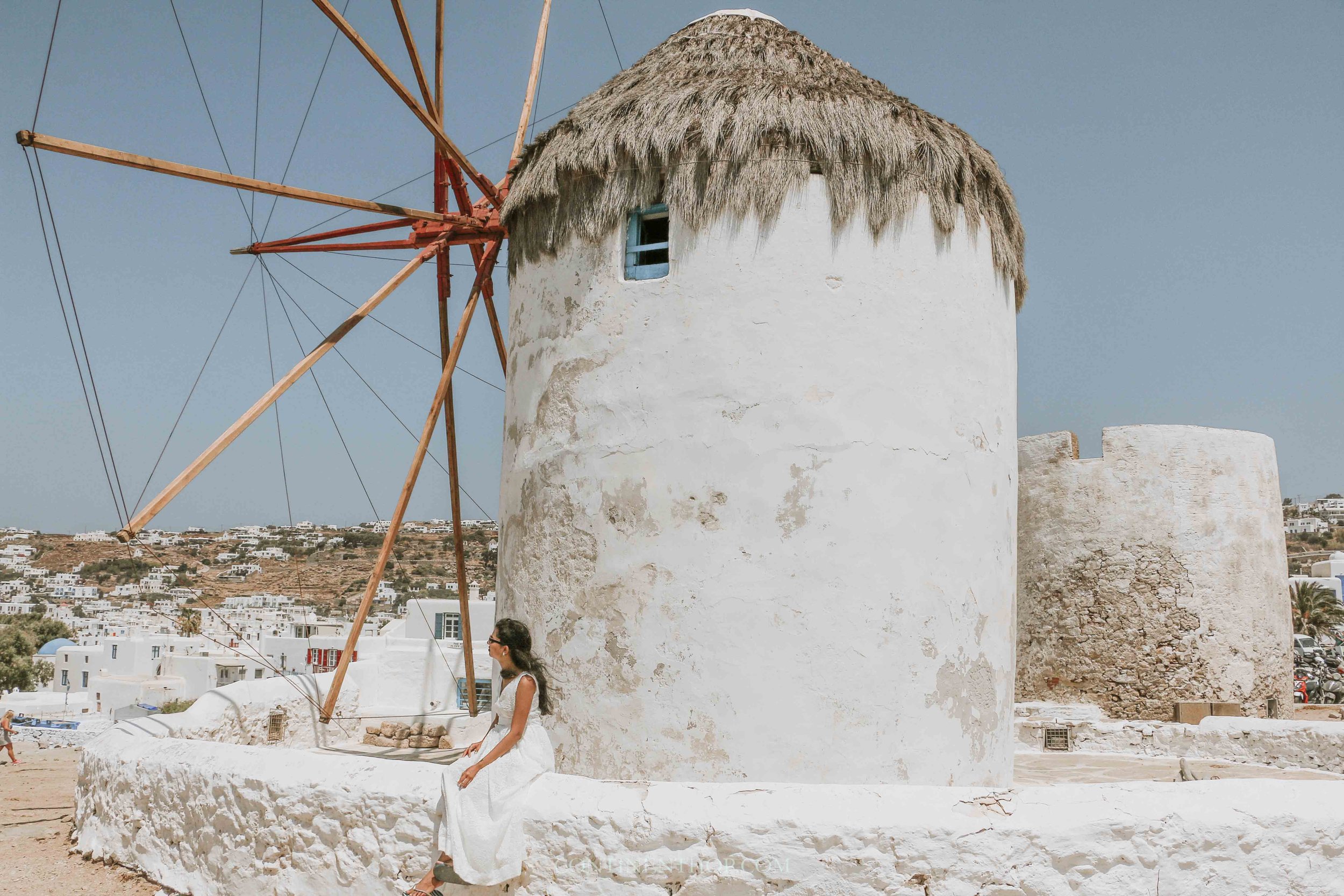 Woman sat at windmills in mykonos how many days in mykonos is enough