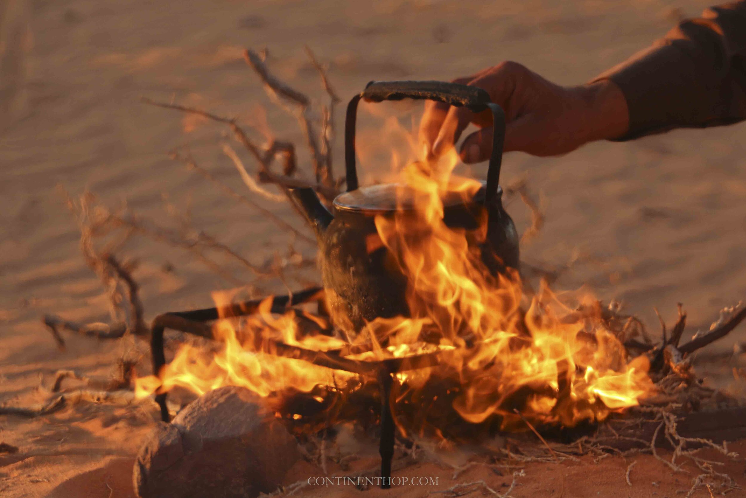 Jordan country image of a kettle placed on firewood and flames in Wadi Rum