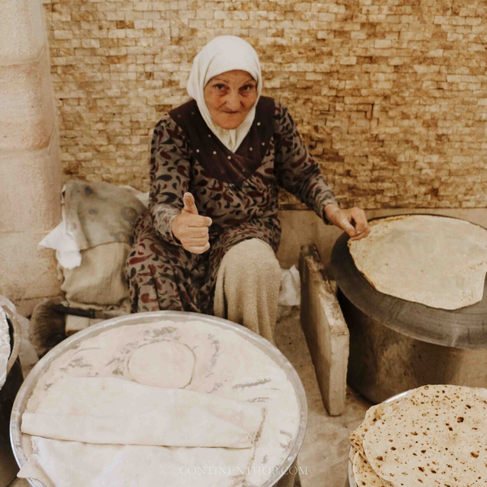 Image of old woman making bread in Jordan