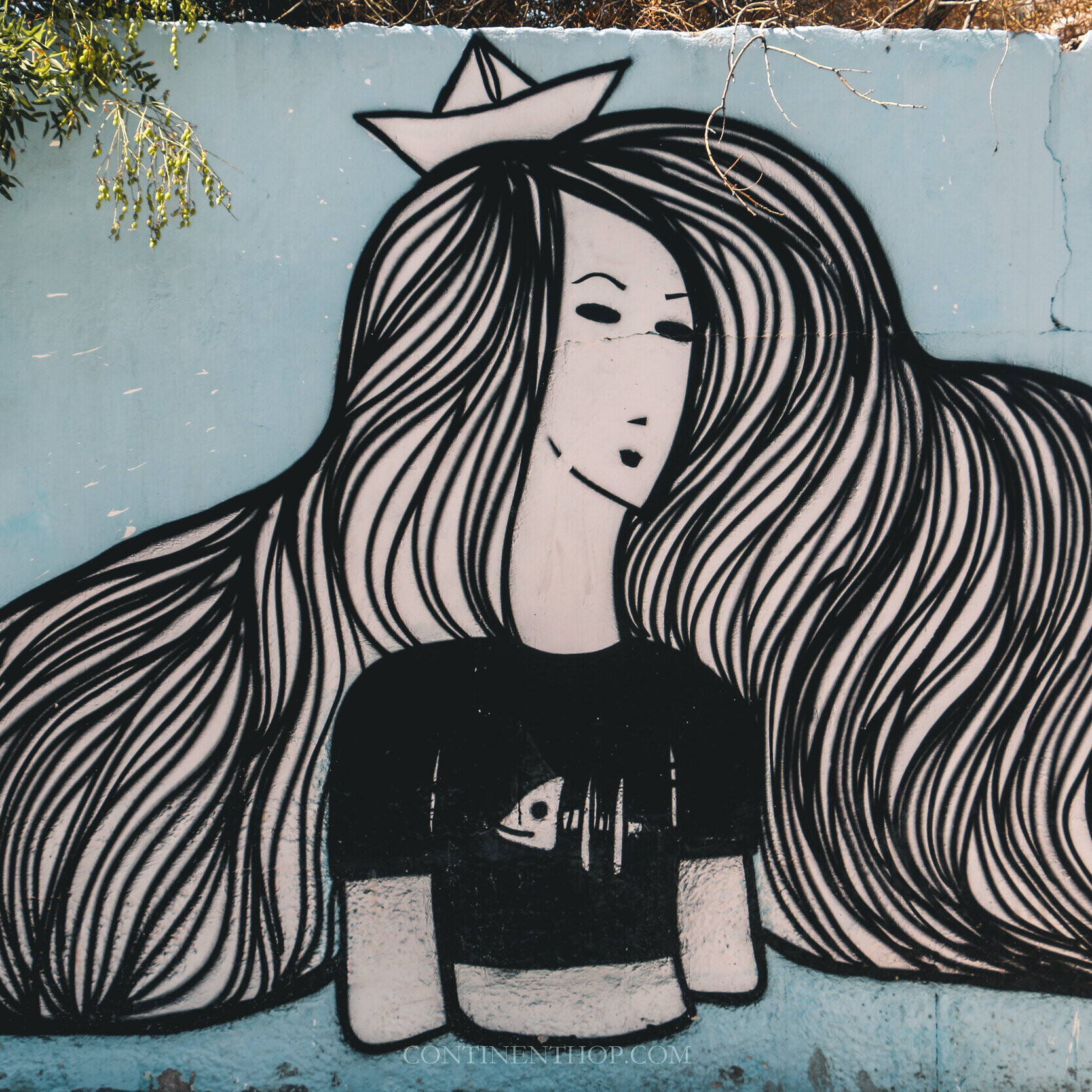 Image of a mural of a girl on a blue wall in Jordan