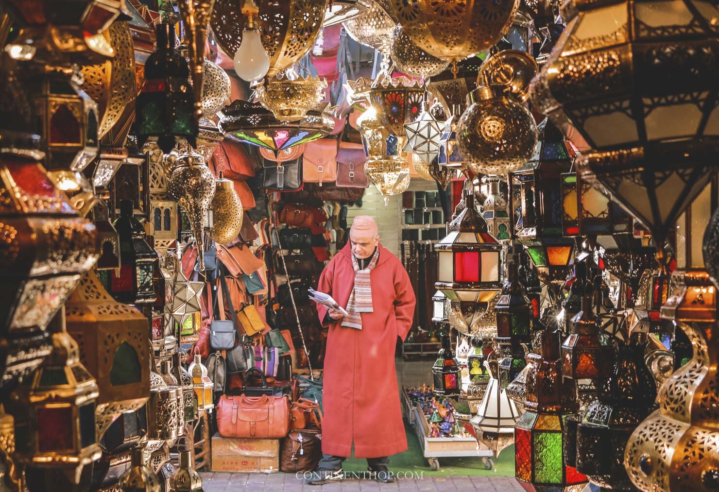 lantern vendor reading a newspaper in the souks of Marrakech