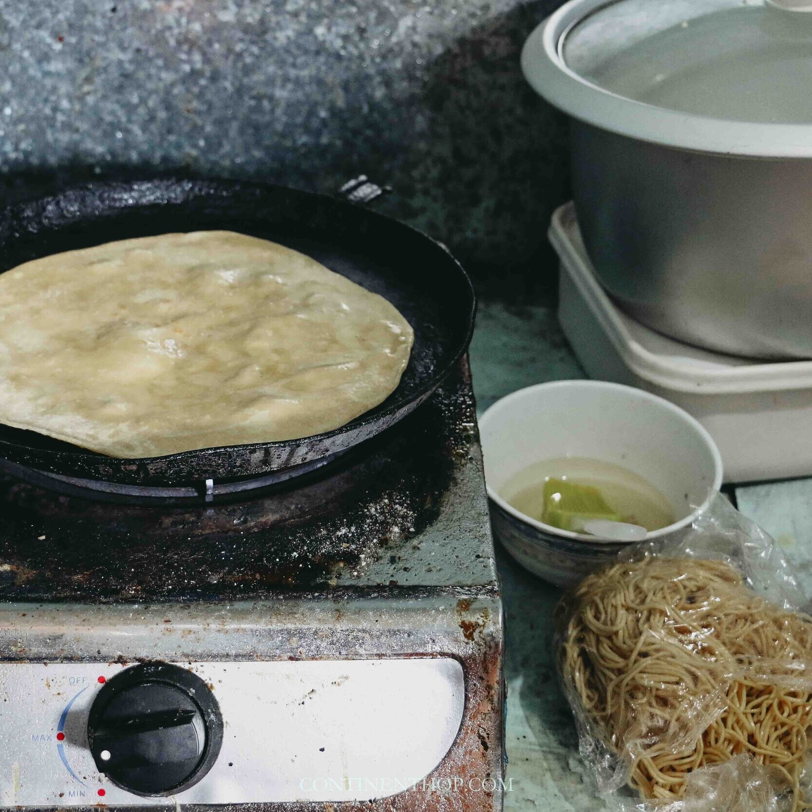 Mauritius traditional food Dholl puri being roasted on a pan