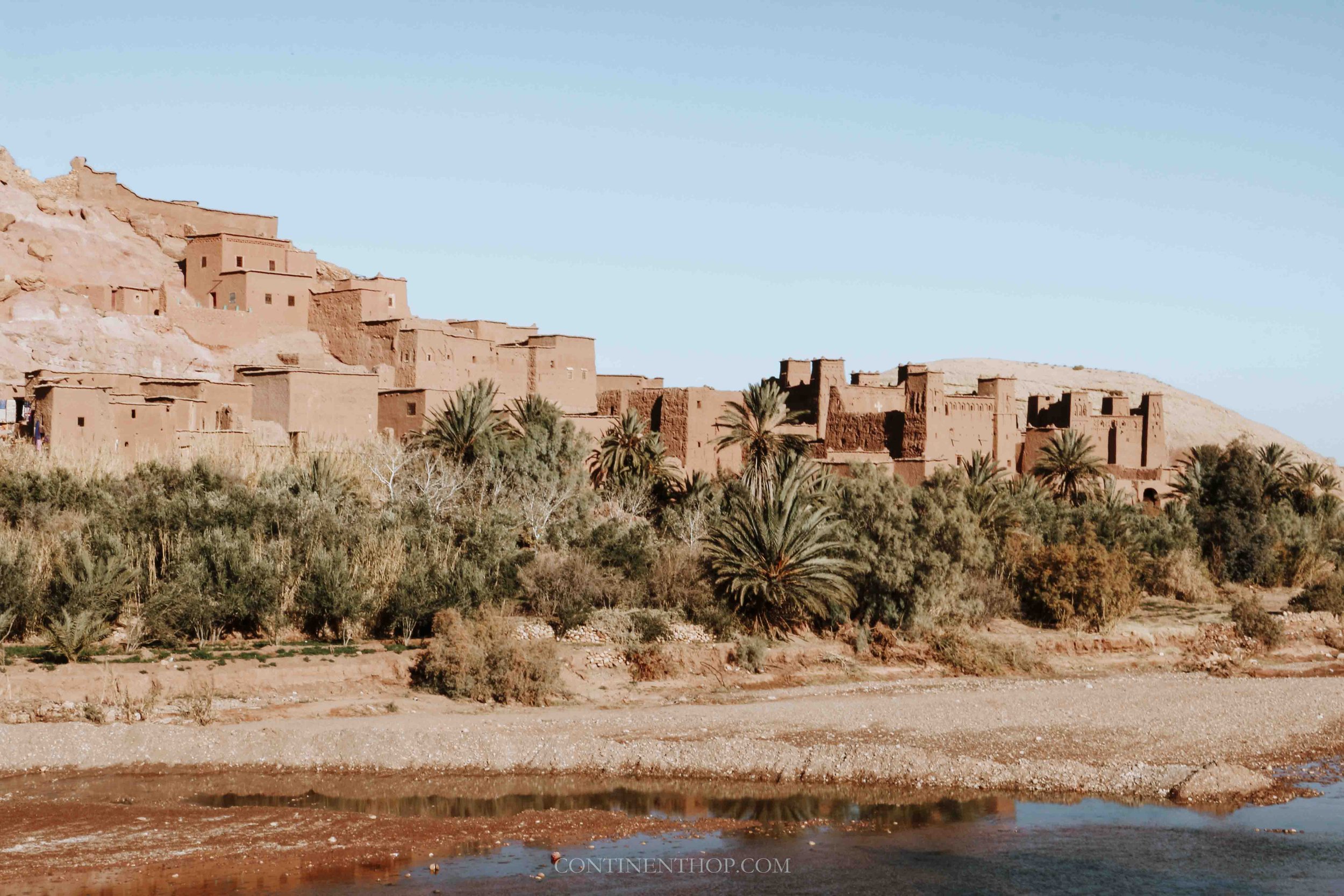 Ait Ben Haddou with palm trees in front in December in Morocco in winter