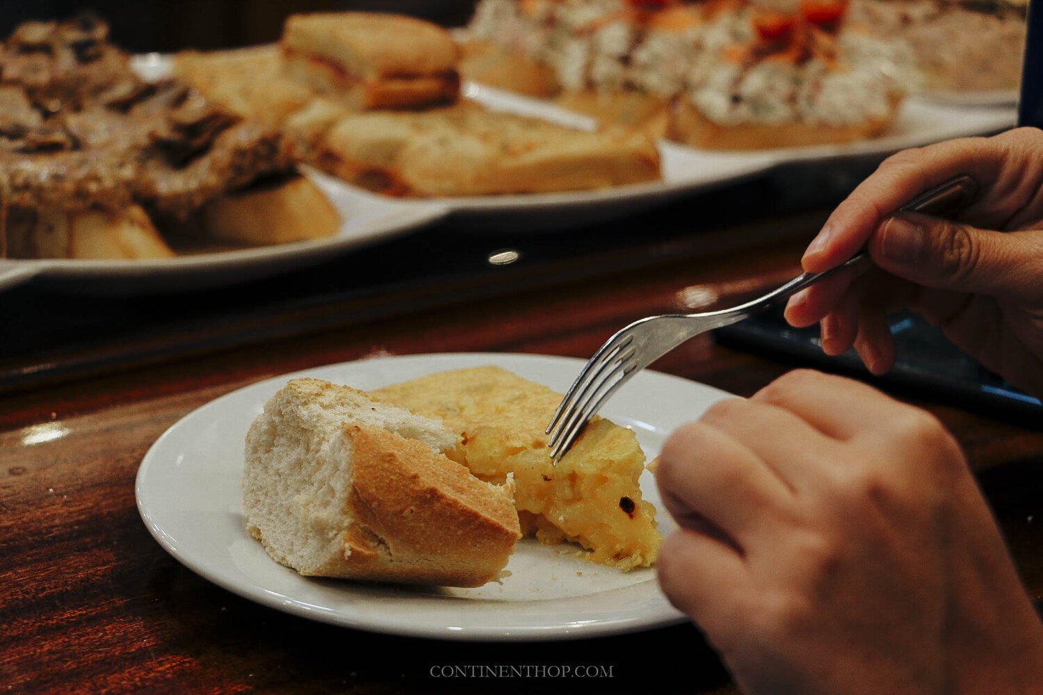 Person eating popular tapas in Spain
