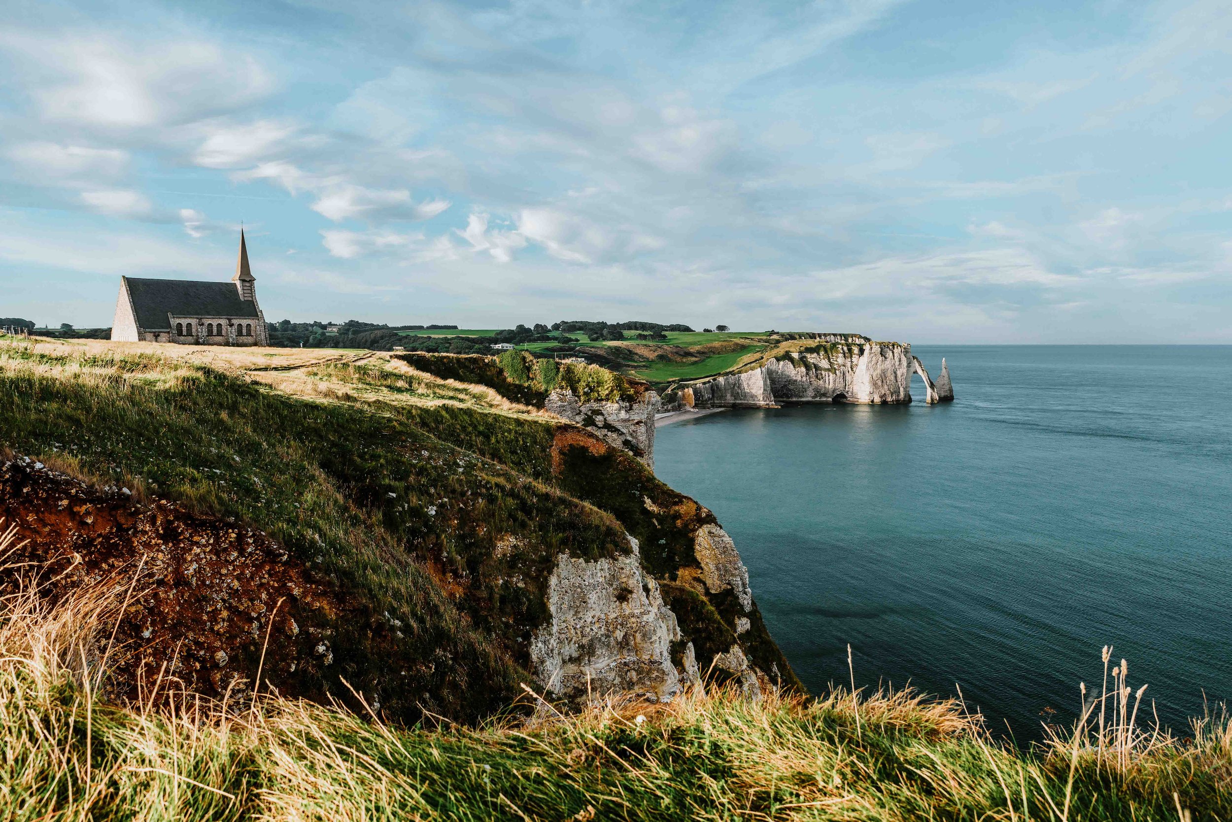 Cliffs of Etretat with a Church on a road trip to Normandy itinerary