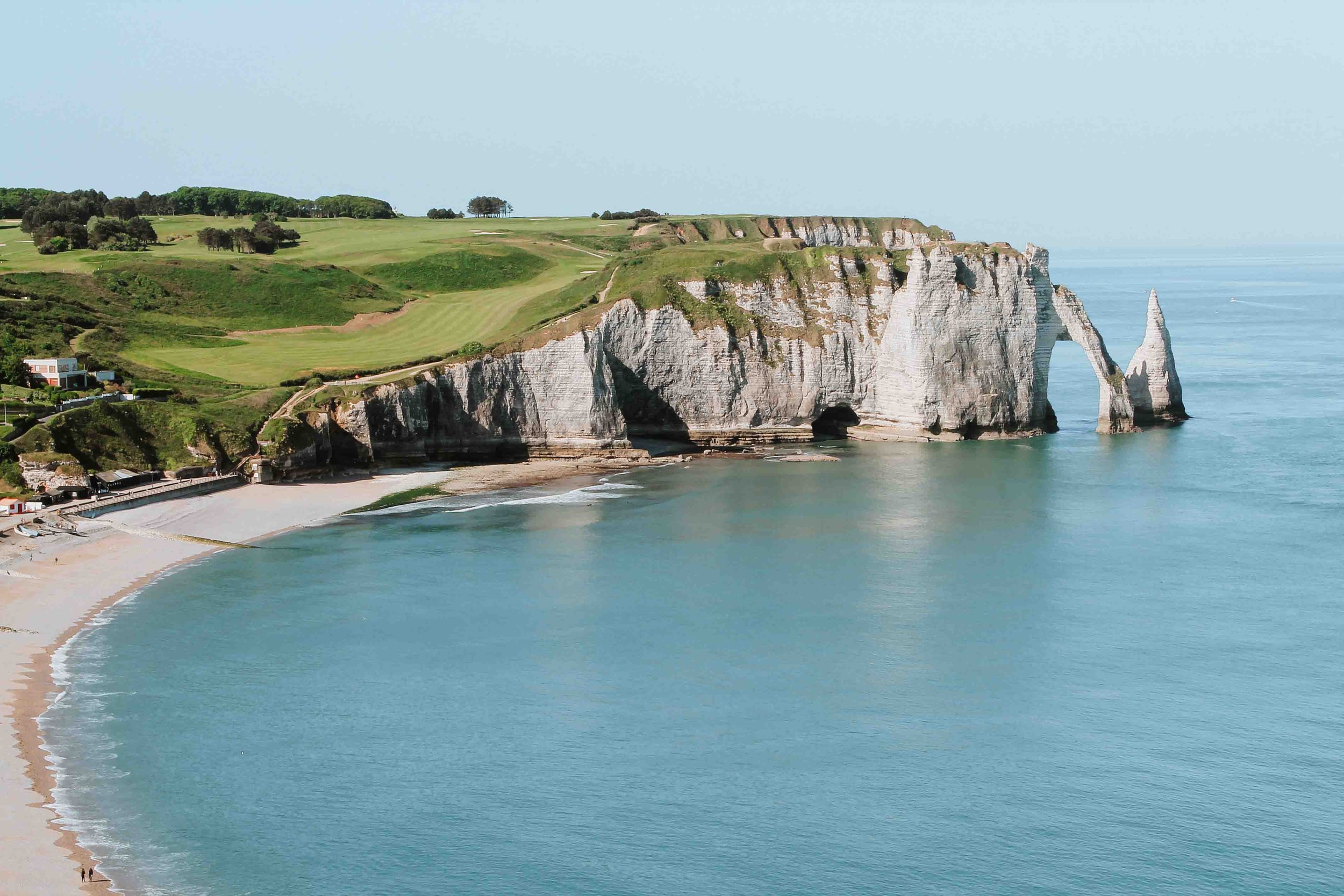 Cliffs of Etretat on a sunny day with the beach on a road trip to Normandy itinerary