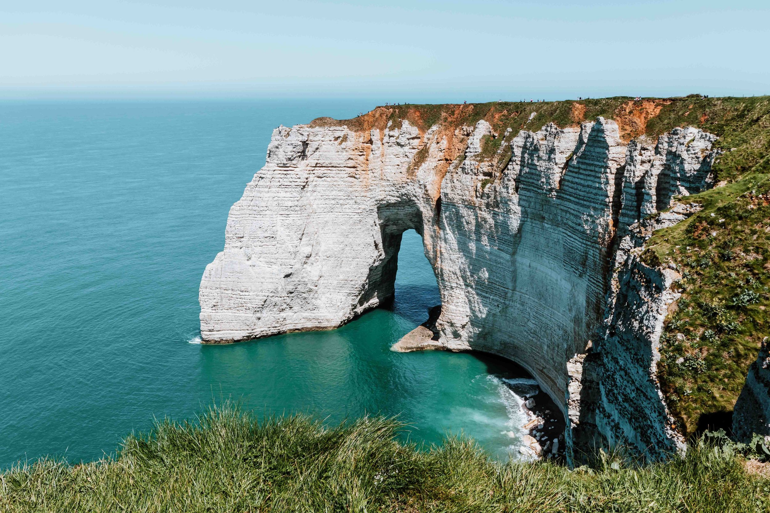 Cliffs of Etretat on a sunny day by the sea on a road trip to Normandy itinerary