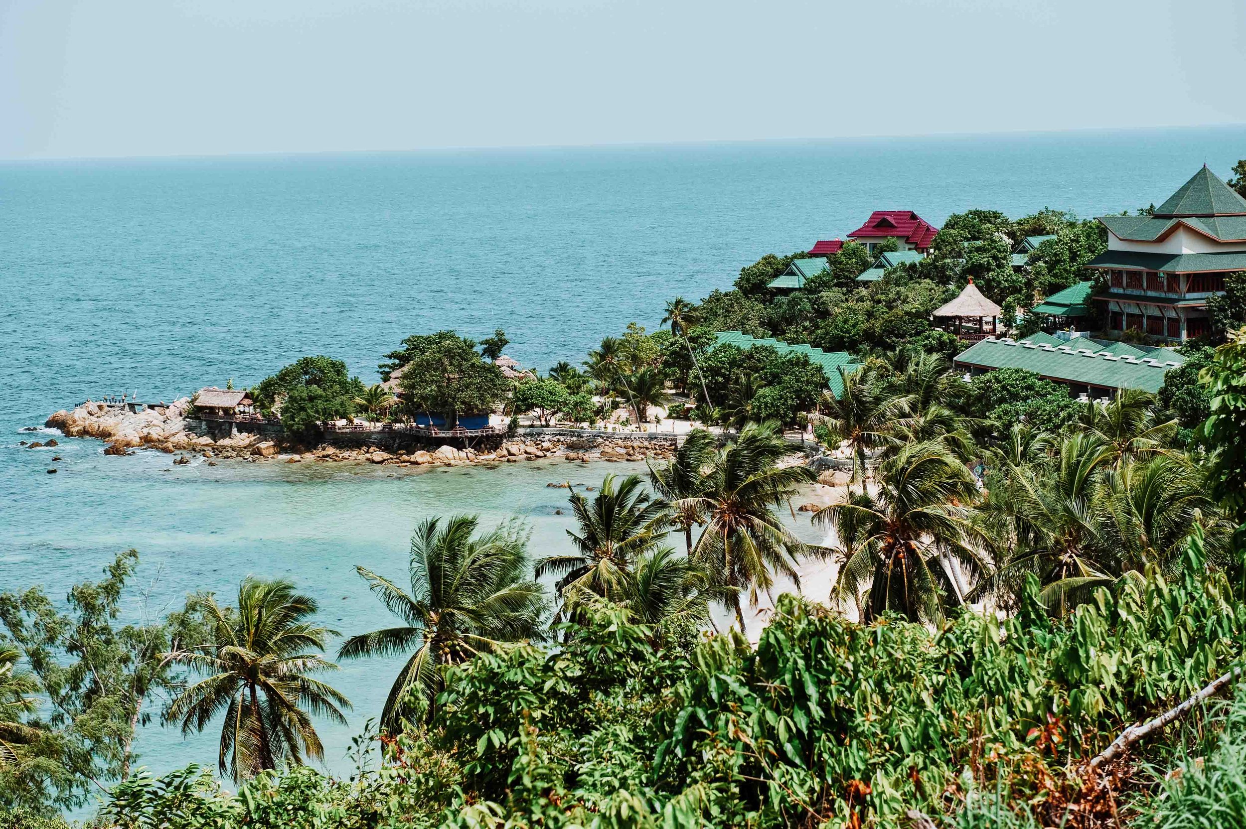 Lush trees and houses by the sea in Koh Phangan on 4 weeks in thailand itinerary
