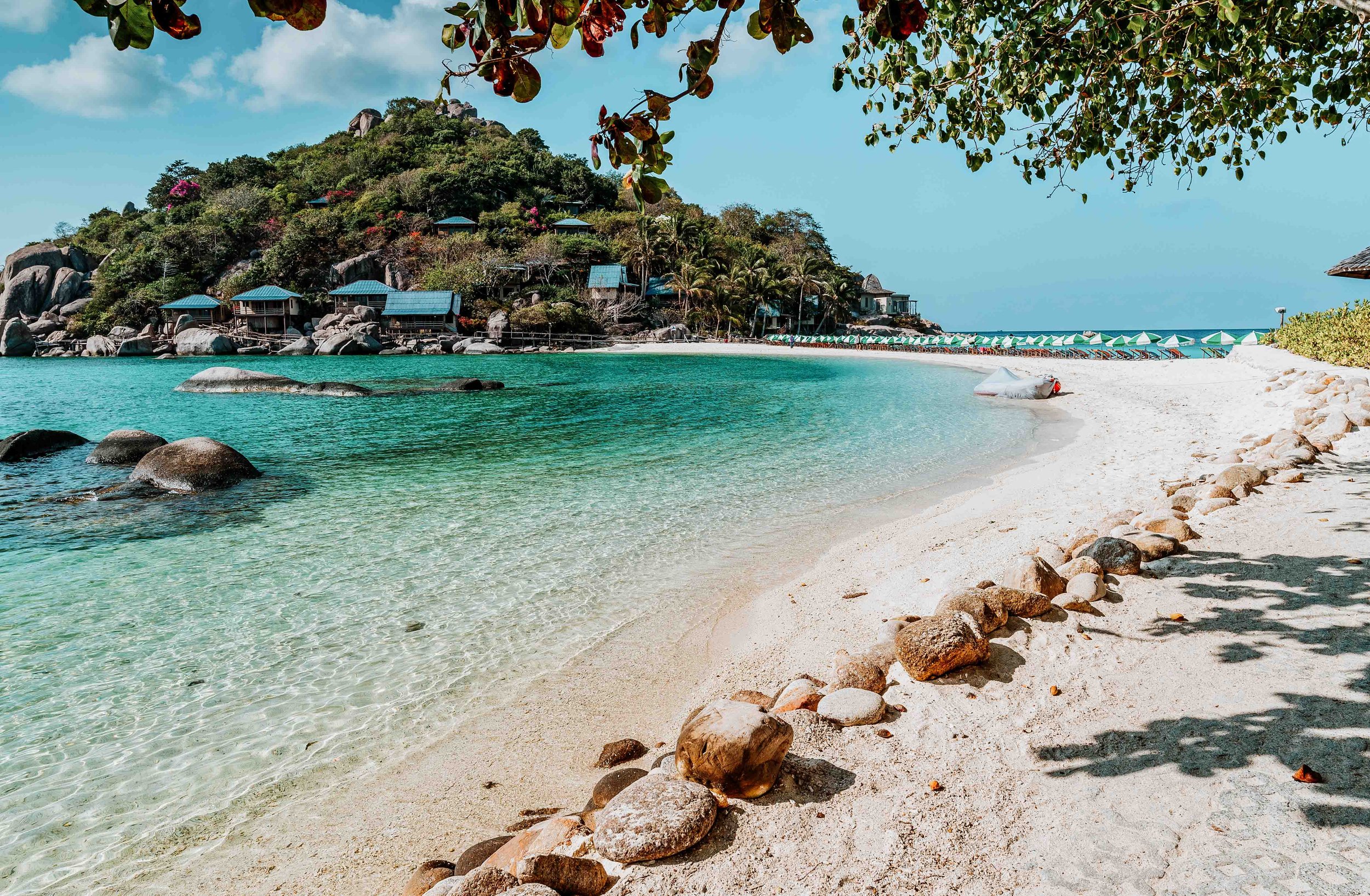 Nang Yuan island on Koh Lao with parasols on beach in a month in Thailand
