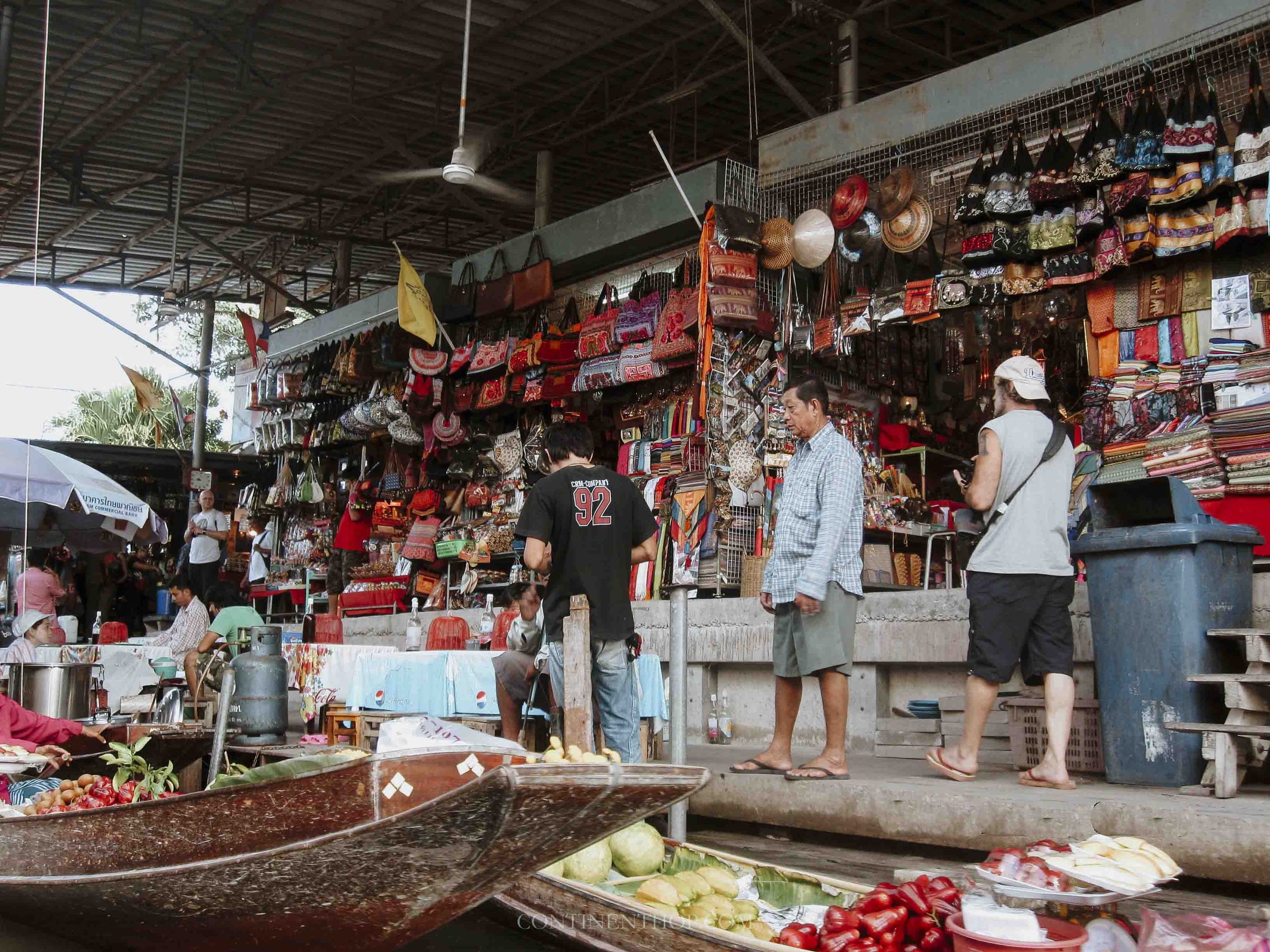 People buying things at floating market in Bangkok on thailand travel itinerary 1 month