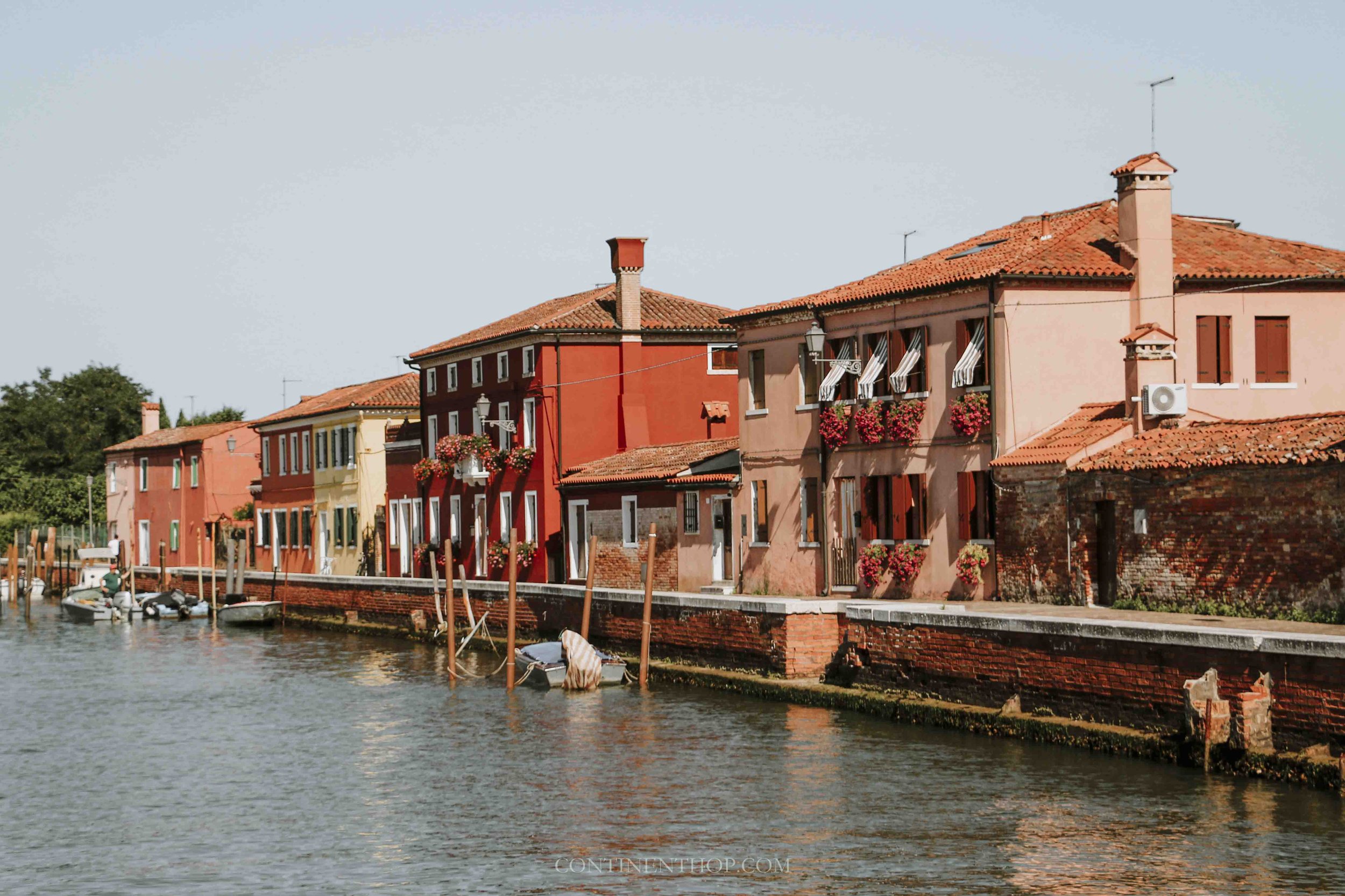 colorful houses in burano by the water - things to do burano venice