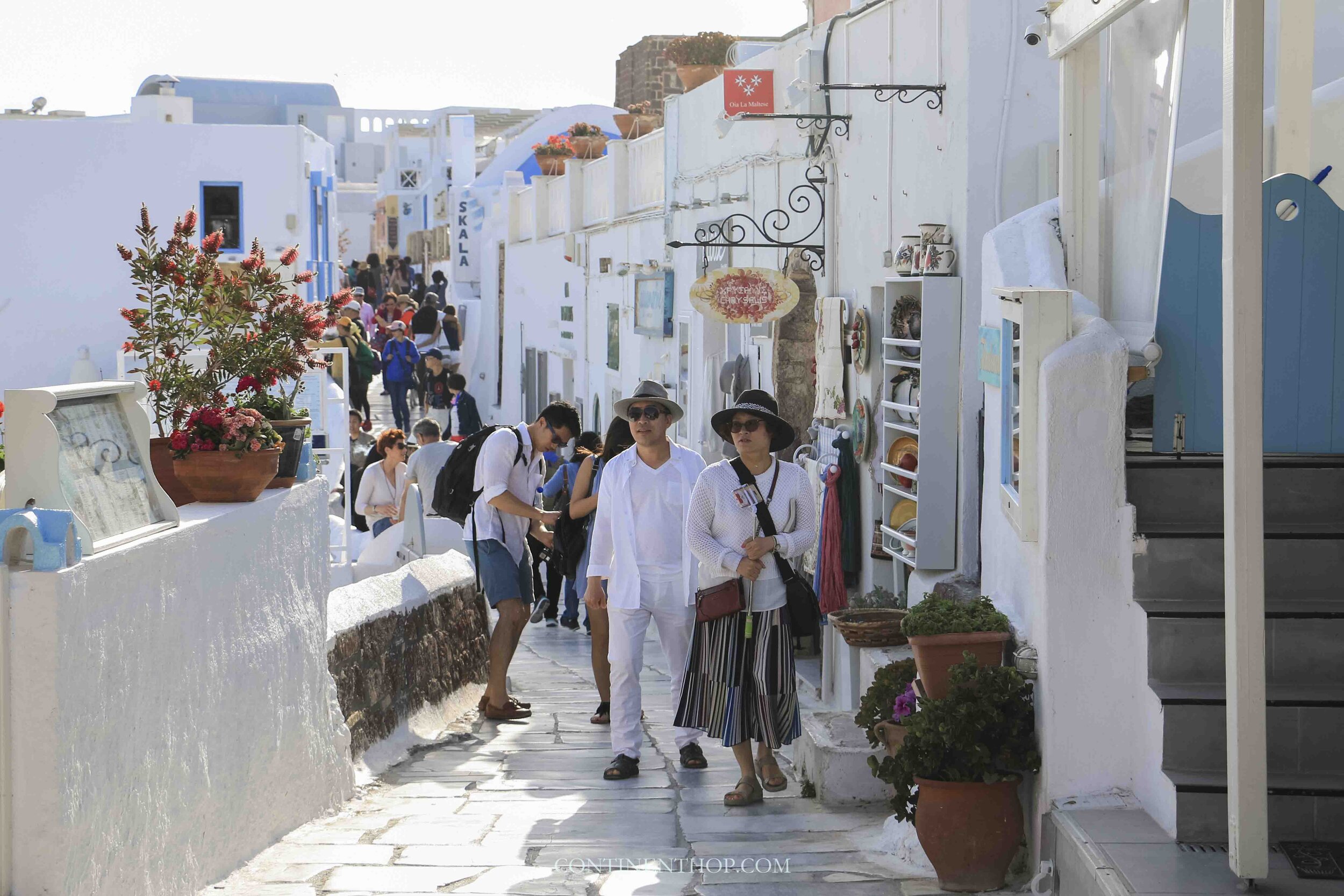 People walking on a street in Oia Santorini
