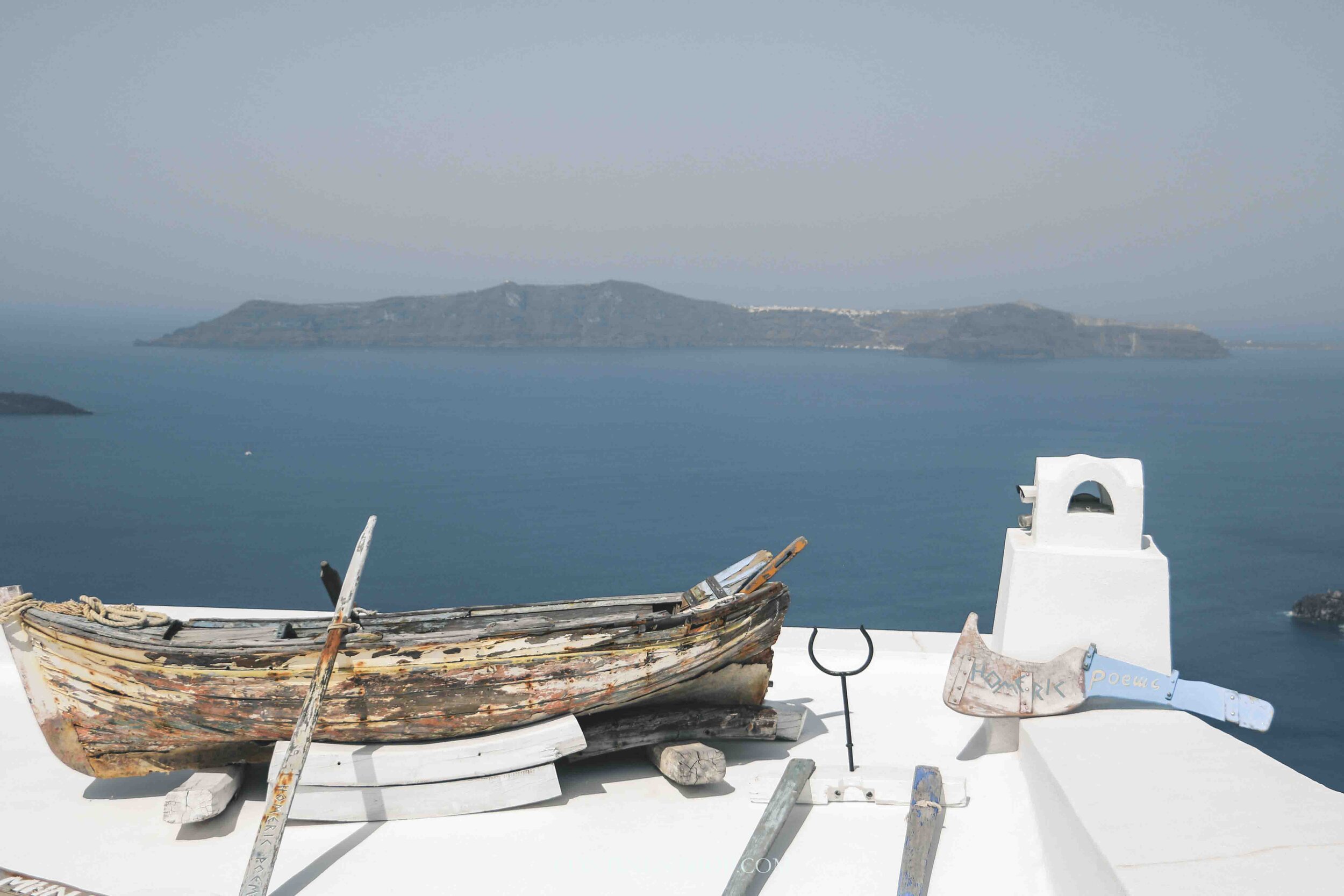 A boat perched on a terrace in Oia Santorini, things to do in Oia Santorini