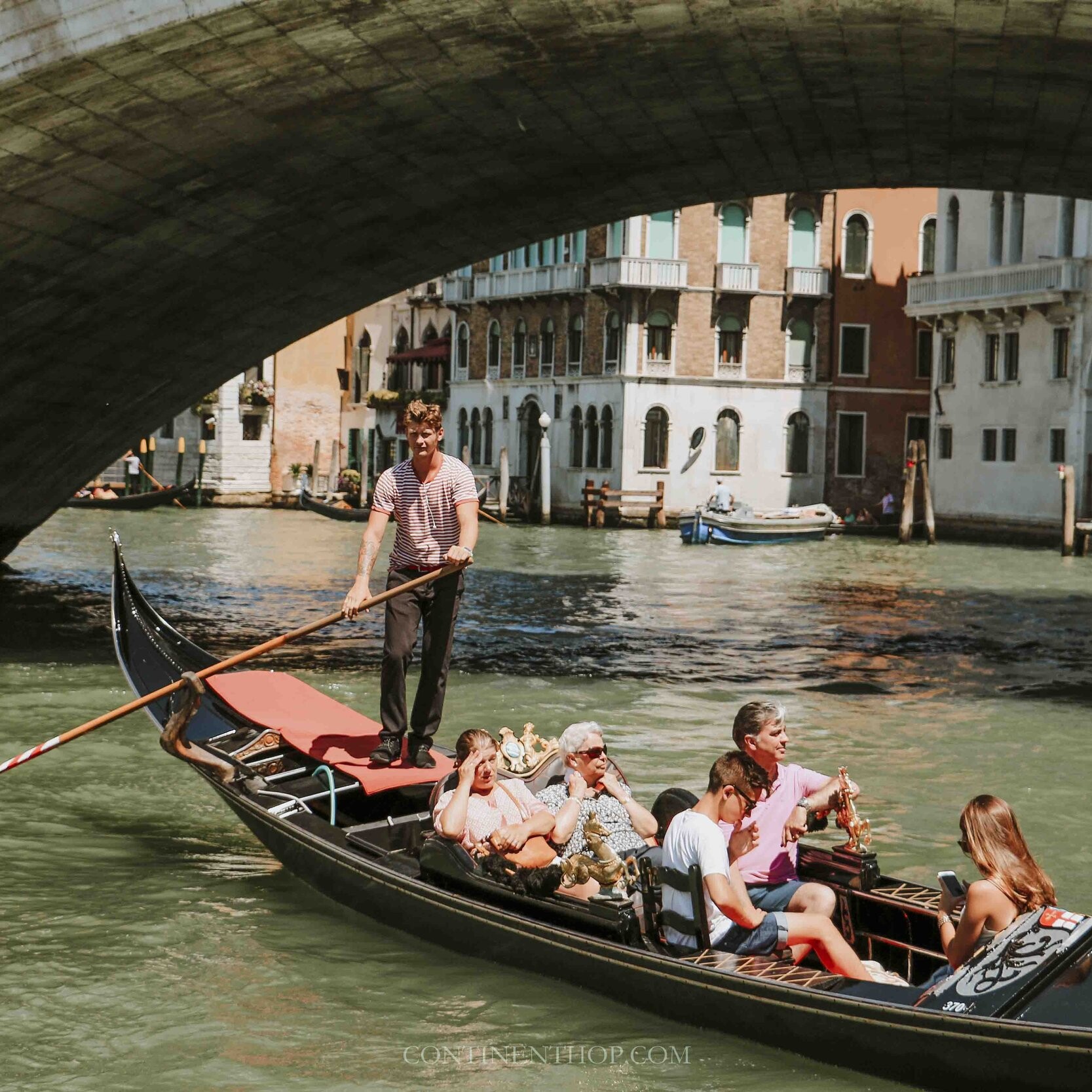 Friends travelling together in Venice in a gondola