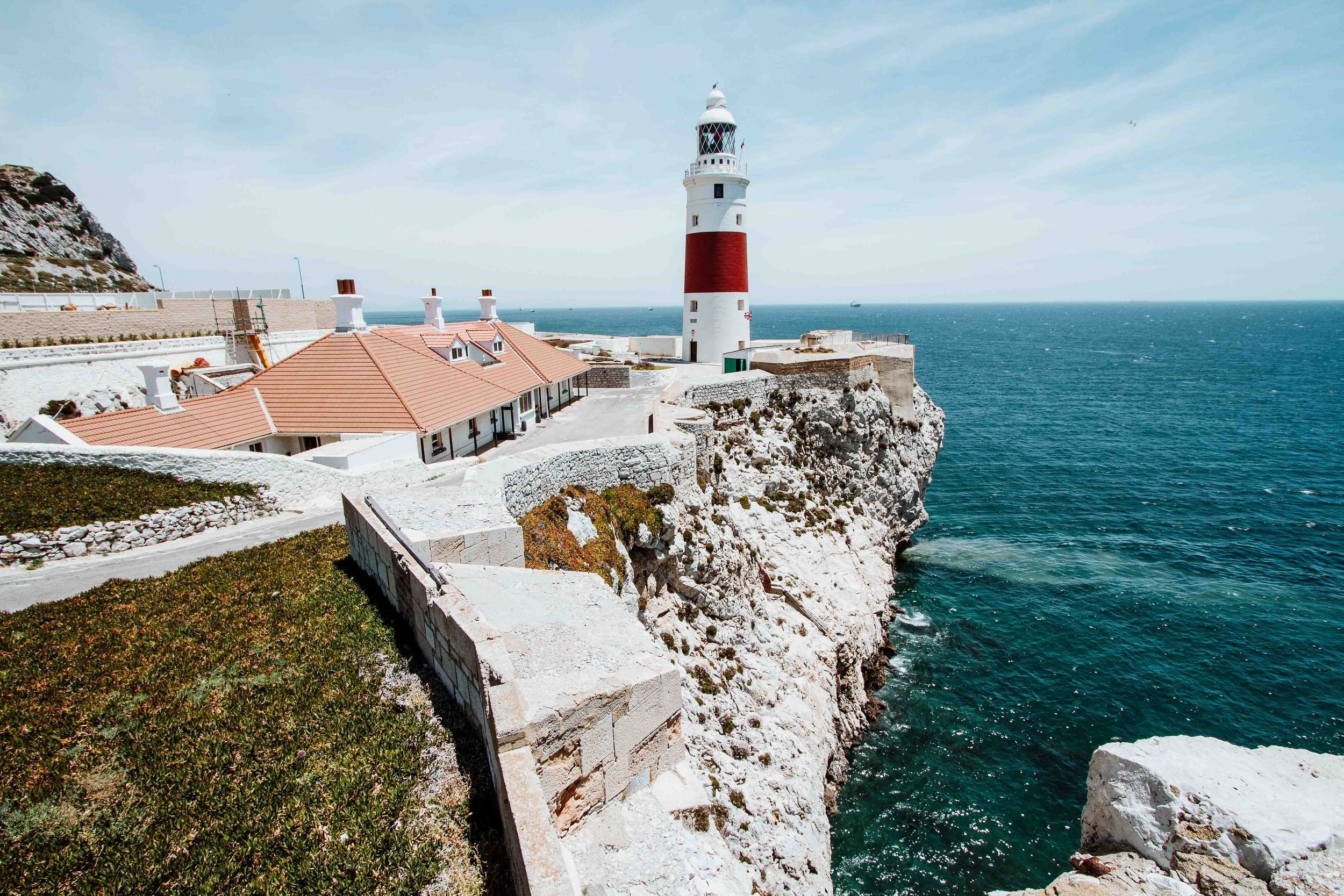 A red and white lighthouse by the cliffside in Gibraltar the Warmest places in Europe in April