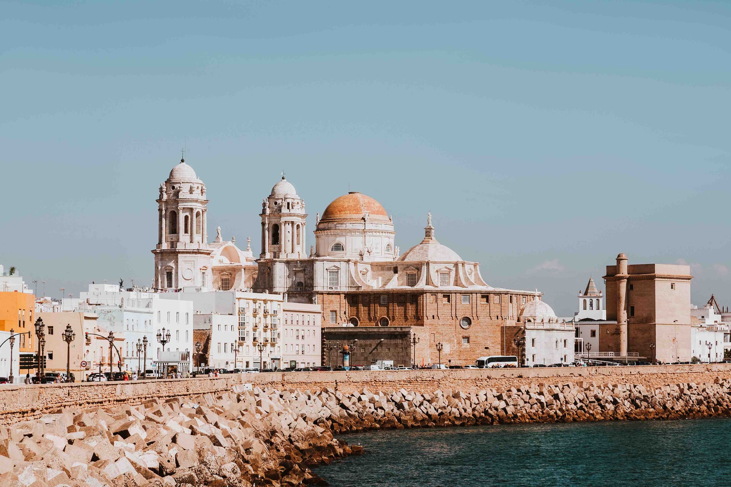 Warmest places in Europe in March - the coastline in Cadiz with historic buildings and turrets