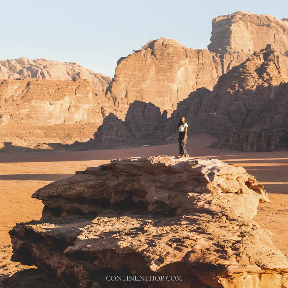 Best places in Jordan Woman standing on rock in Wadi Rum