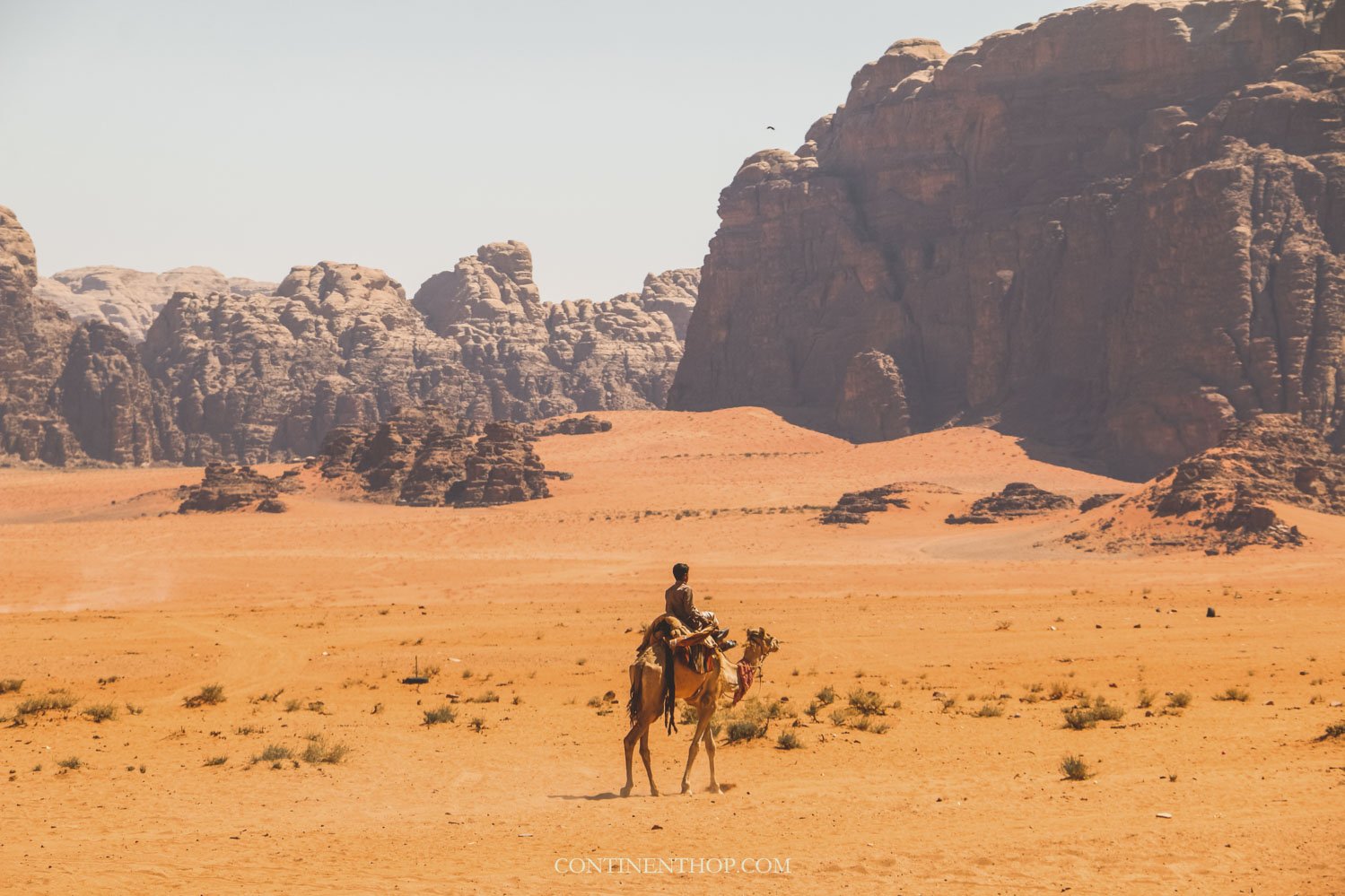 Jordan tourist spots Man on camel in Wadi Rum