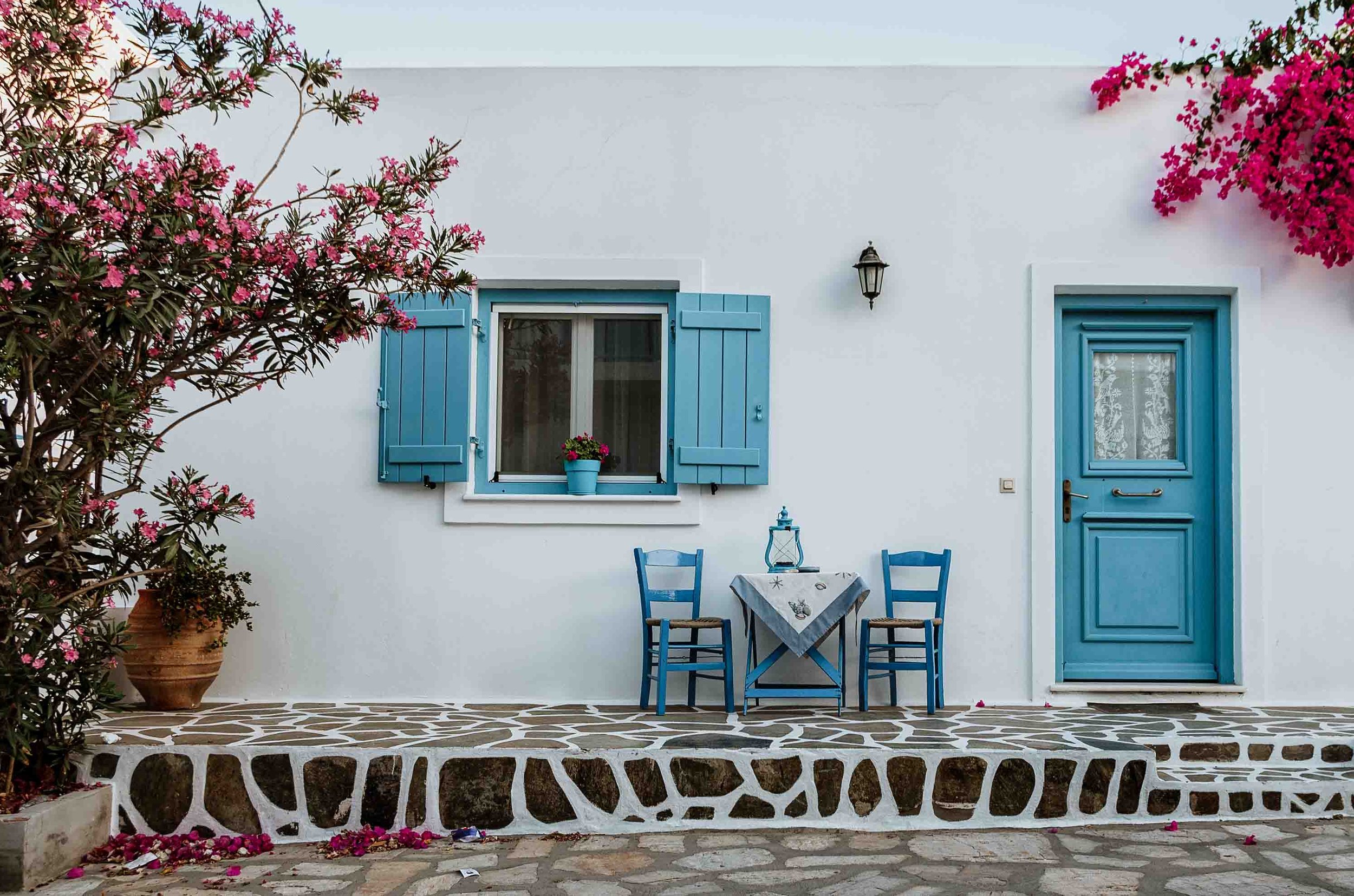 Blue windows and door by the street in Antiparos one of the Warmest places in Europe in April