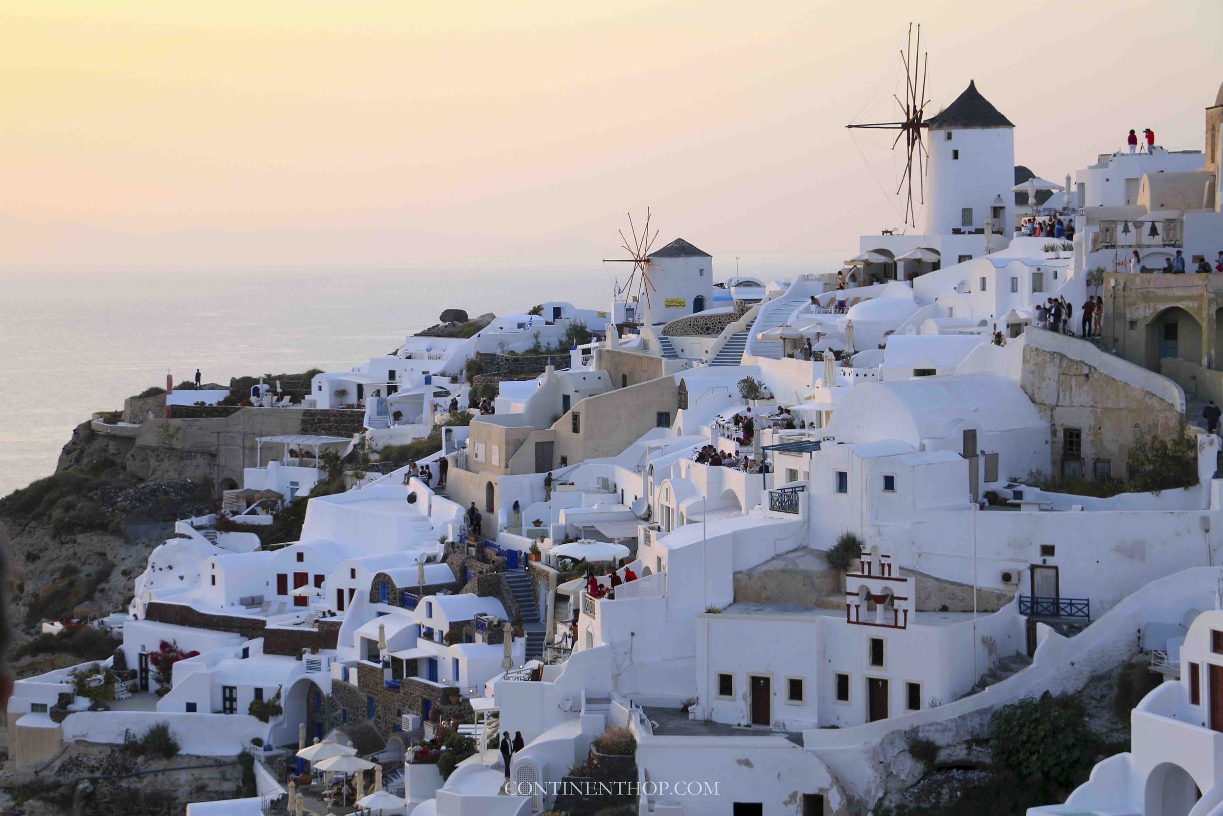 Whitewashed houses in Santorini with windmills why visit santorini greece