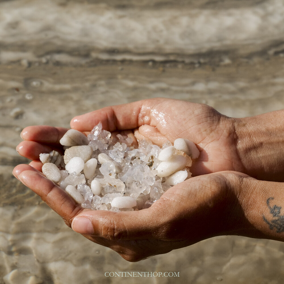 Woman holding salt crystals from the Dead Sea