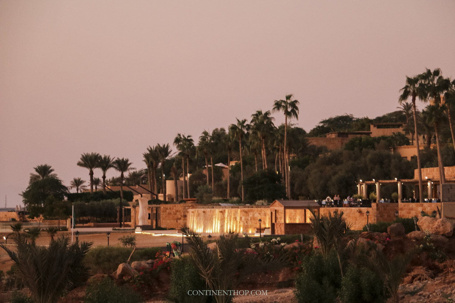 Orange glow of the sun over a dead sea resort on the way from Amman to the Dead Sea