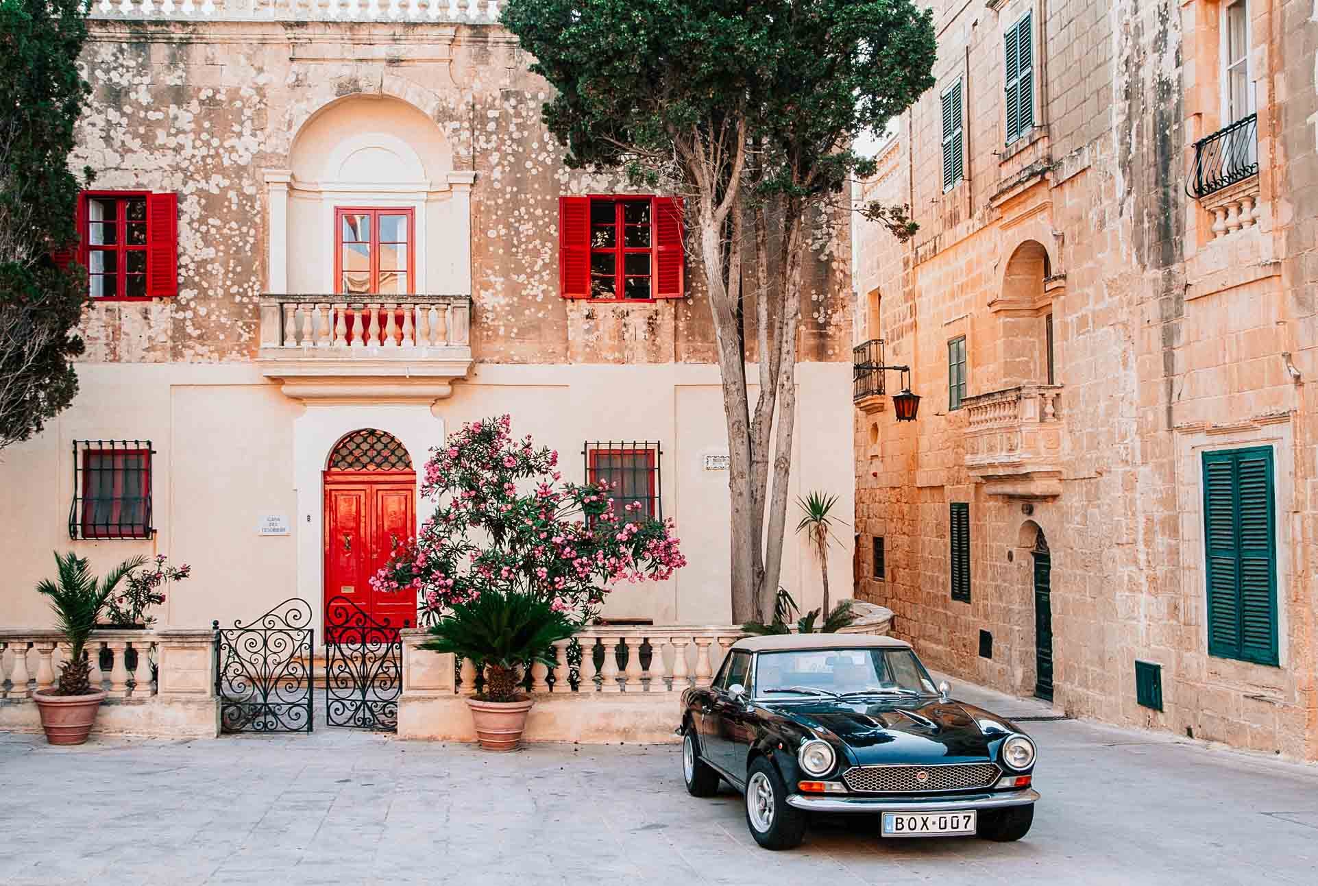 A car parked outside a rustic house in the Mdina from Valletta Mdina via buses to Mdina