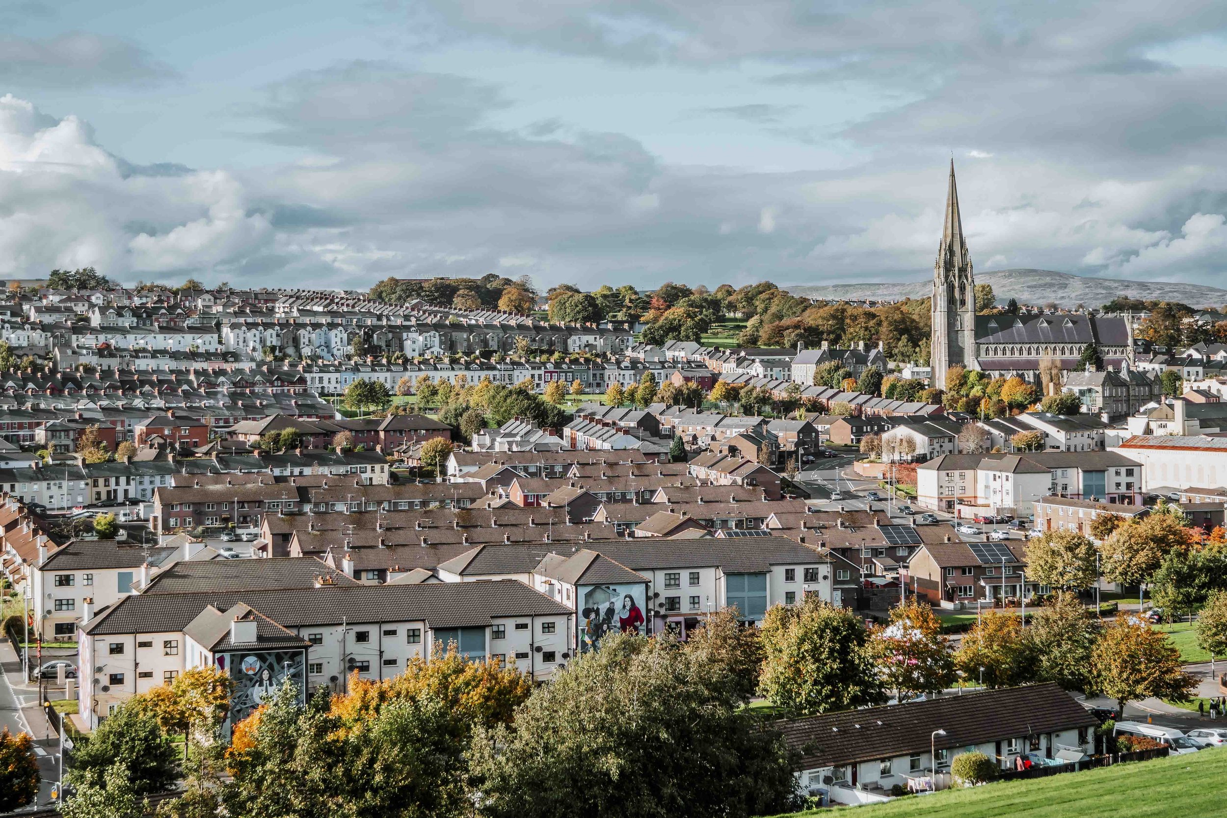 View of village of Derry with church on road trips northern ireland