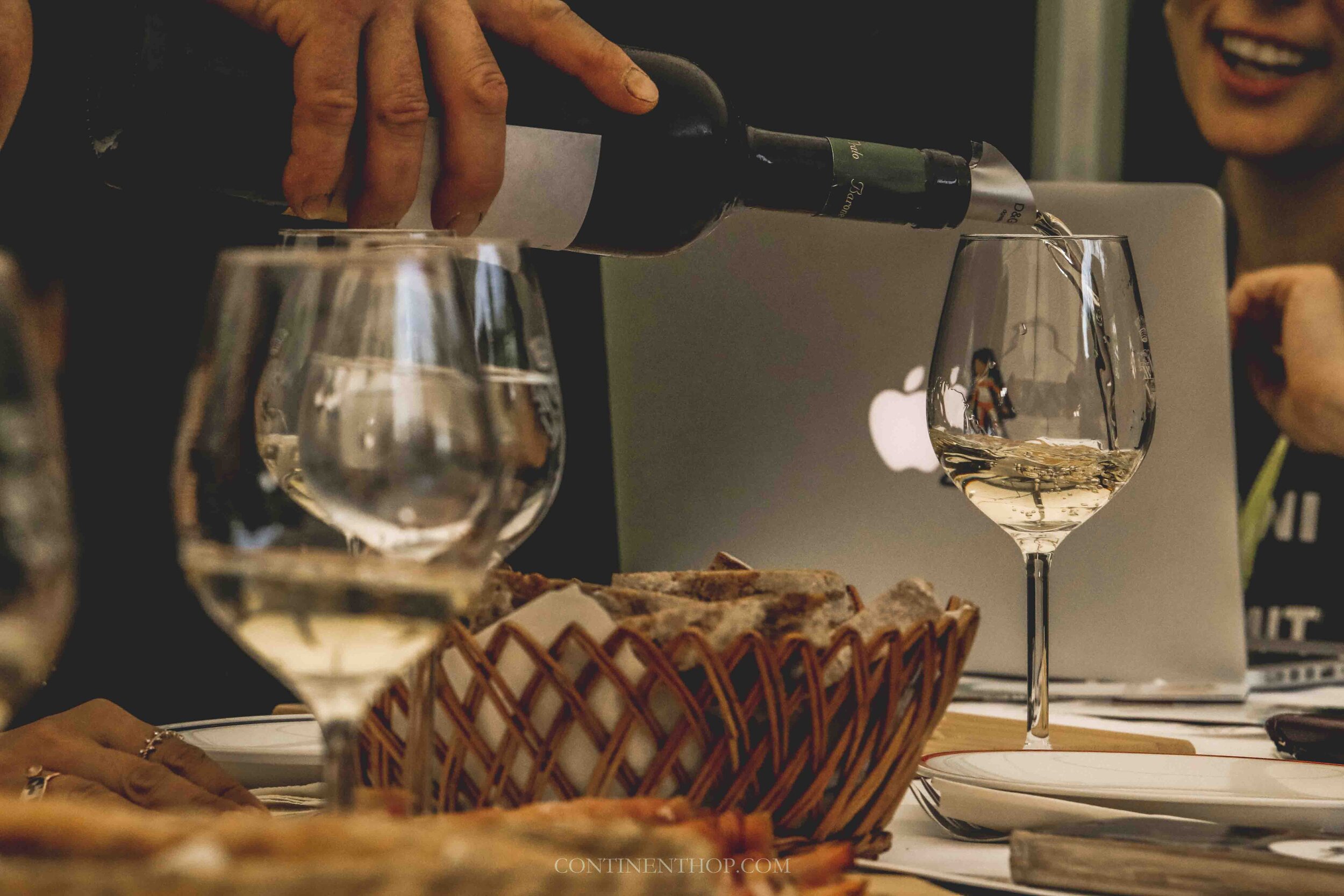 Person pouring wine in a glass at Cantina Dei Baroni in Valle Di Cembra - Trentino - Italy