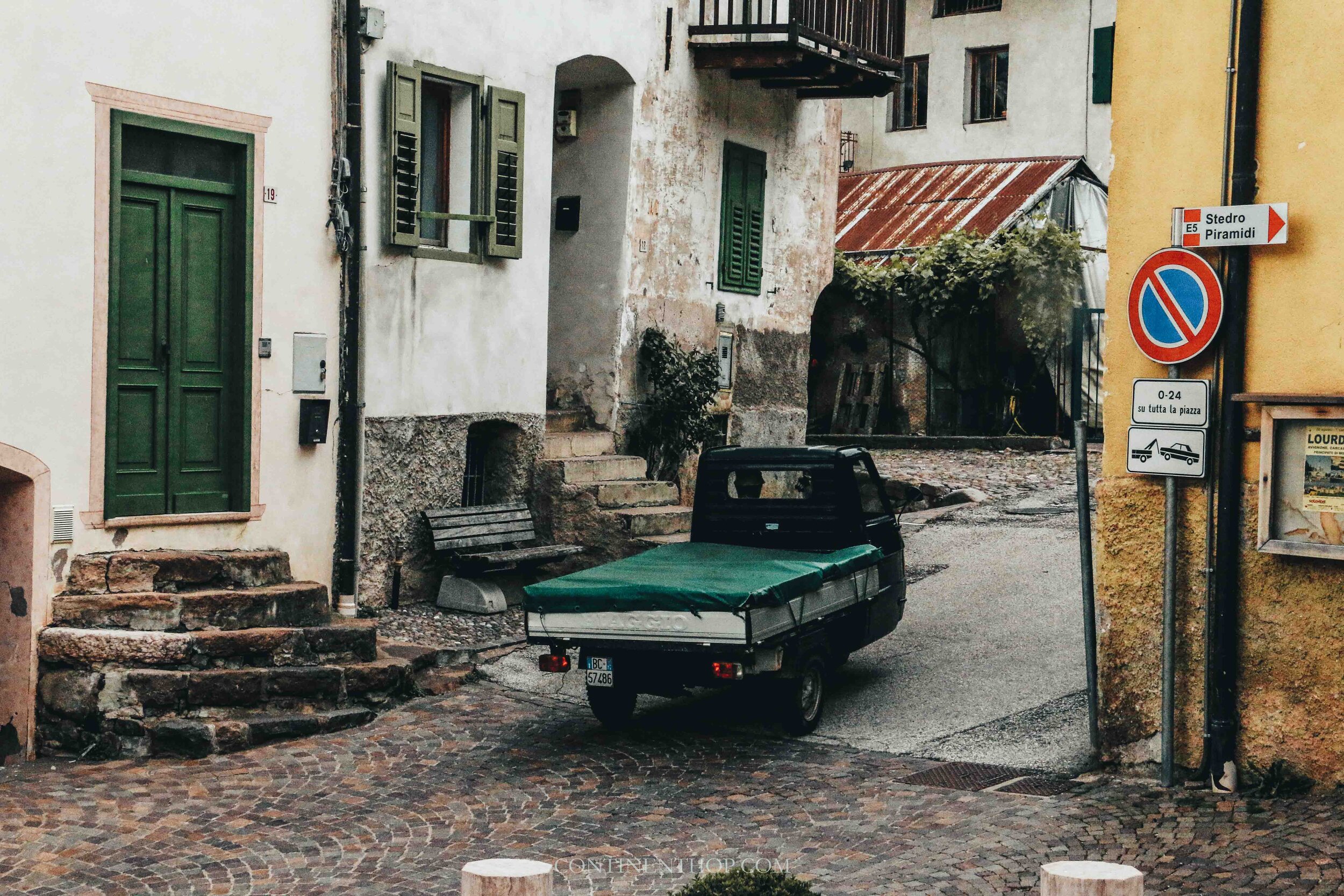 A small green van on a street in Valle Di Cembra Trentino Italy