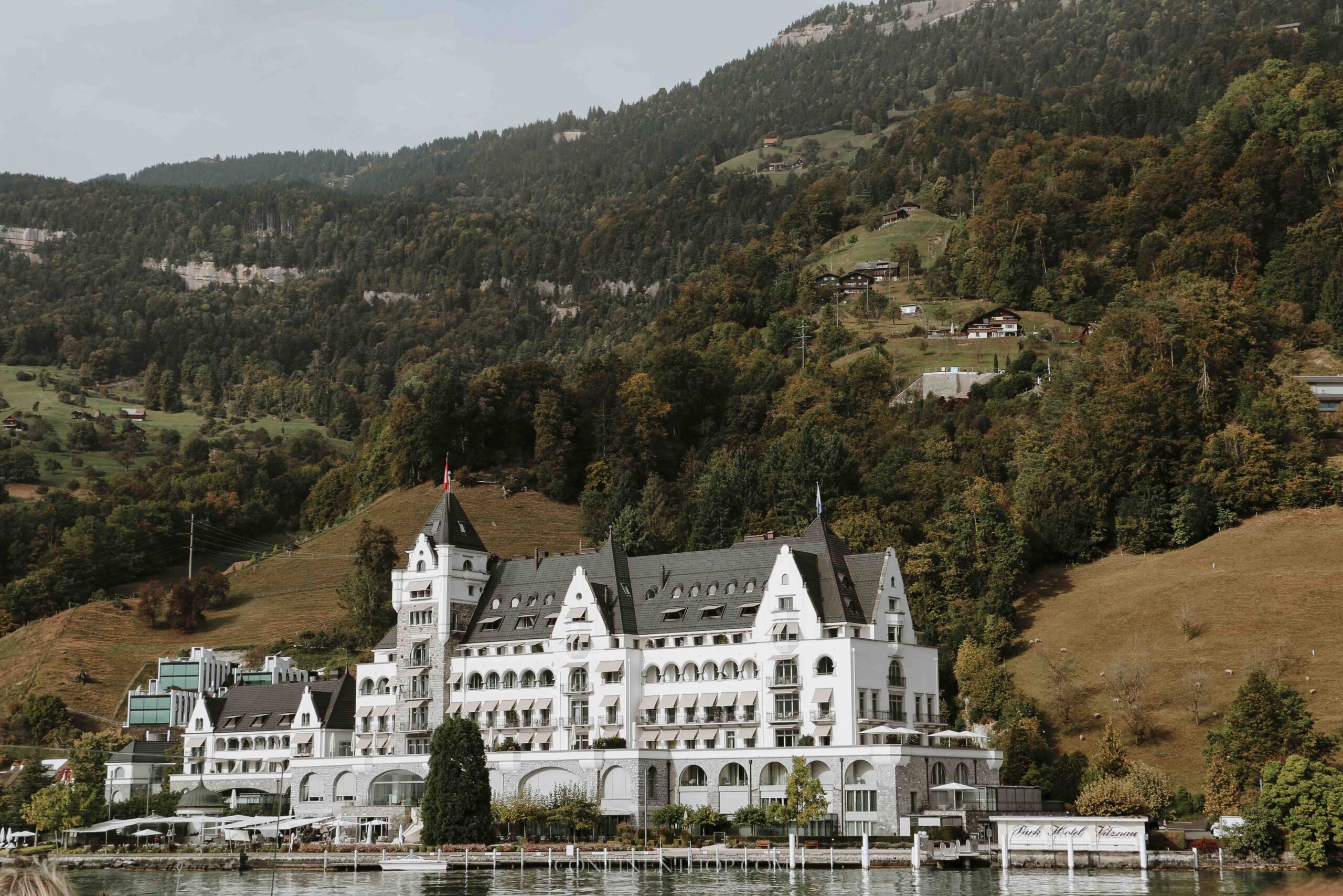A white chalet by the river on a 2 week Switzerland itinerary