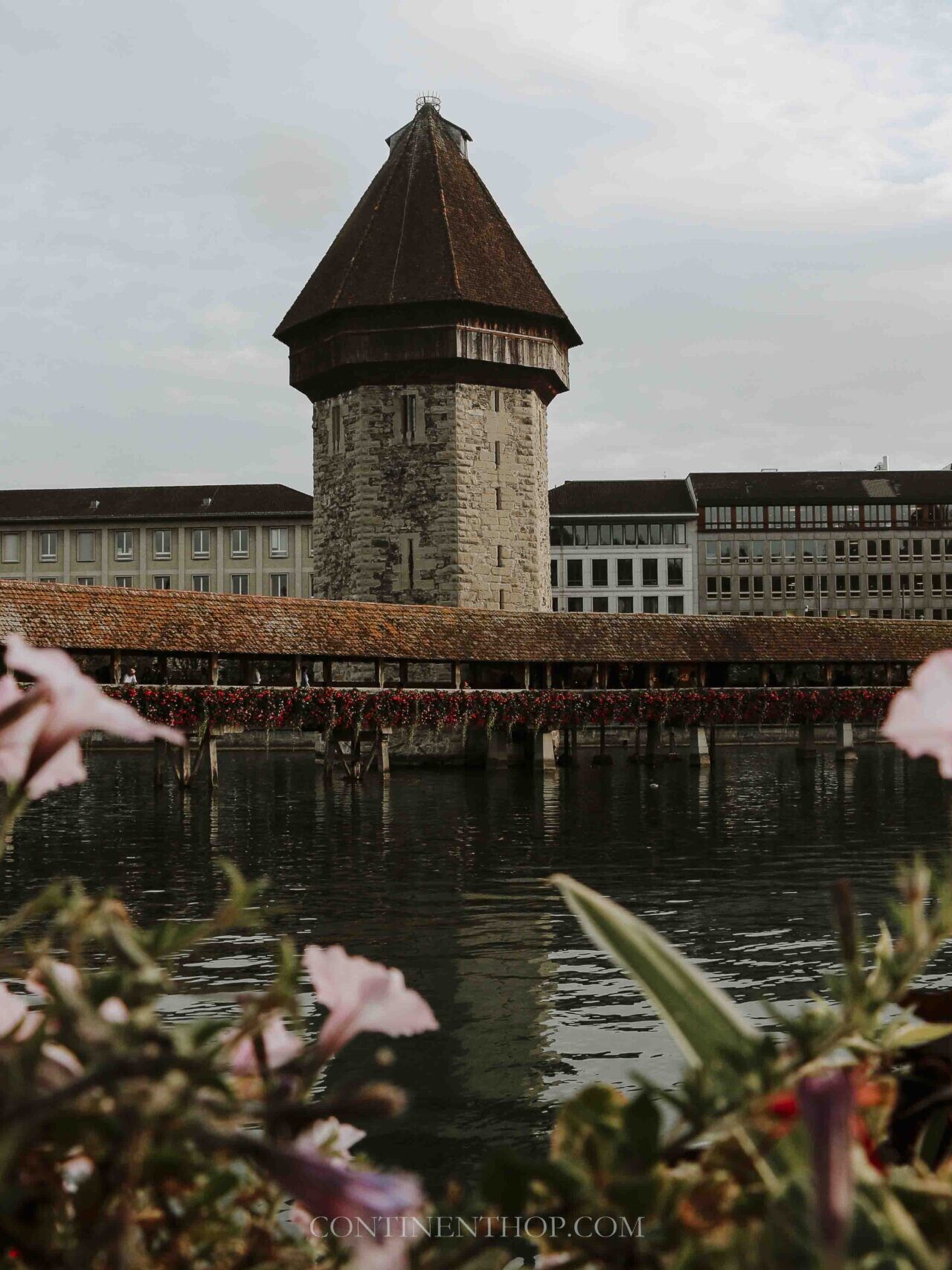 The clocktower of Lucerne by the river on a Switzerland itinerary 14 days in Switzerland itinerary